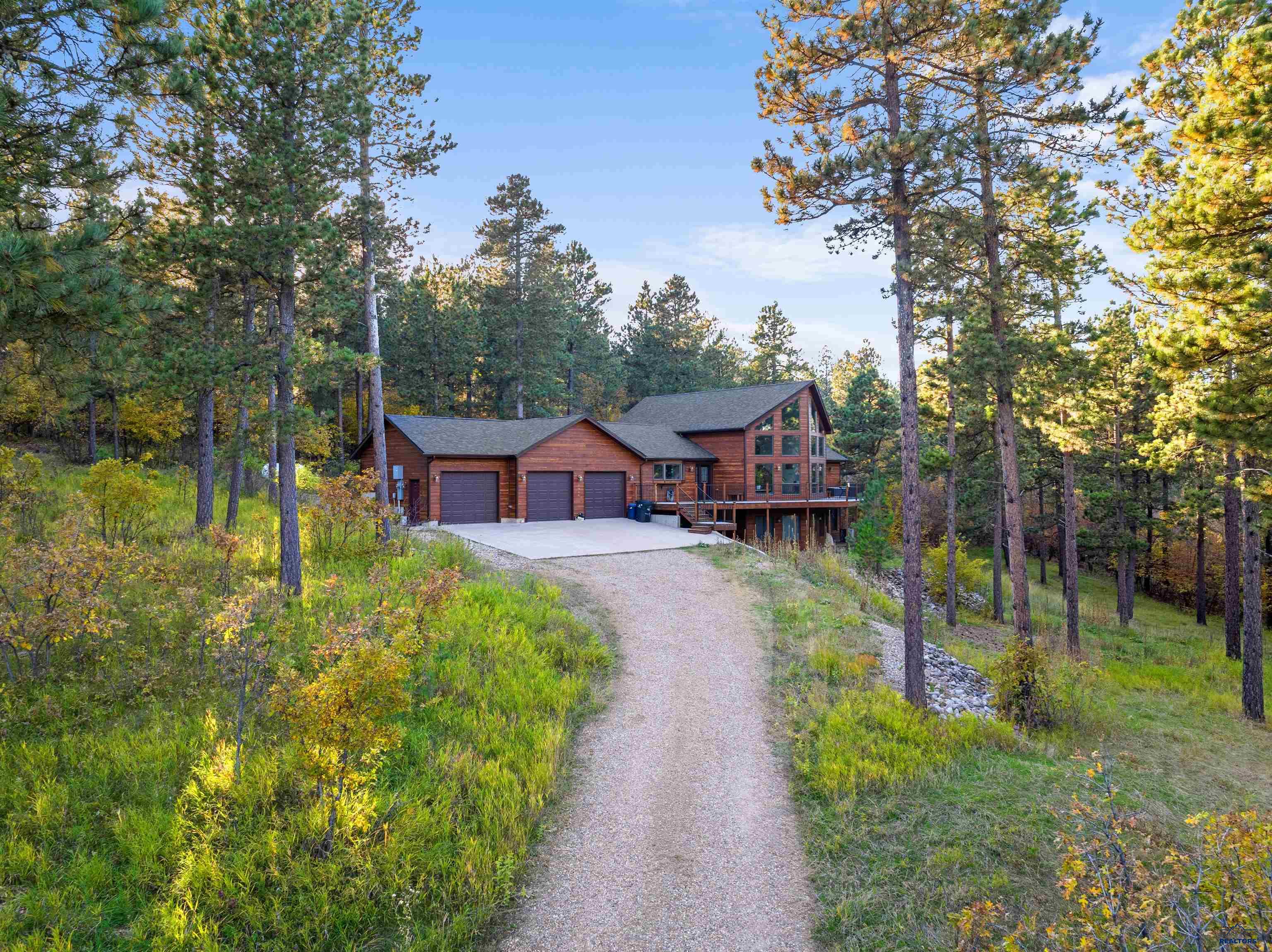 Listed by Tashi Braun -ReMax In The Hills, 605-641-3342.  Enjoy this beautiful three bed, three bath home that is situated on just over eight acres in the beautiful Black Hills.  This home boosts and open concept floor plan with floor to ceiling window that allow for amazing views.  Enjoy relaxing or entertaining on the large wrap around deck.  This home features new siding and a new front and back door.  Enjoy working on home projects in your very own 18x18 basement workshop or large heated garage.  This home is a must see and is waiting for you!!!