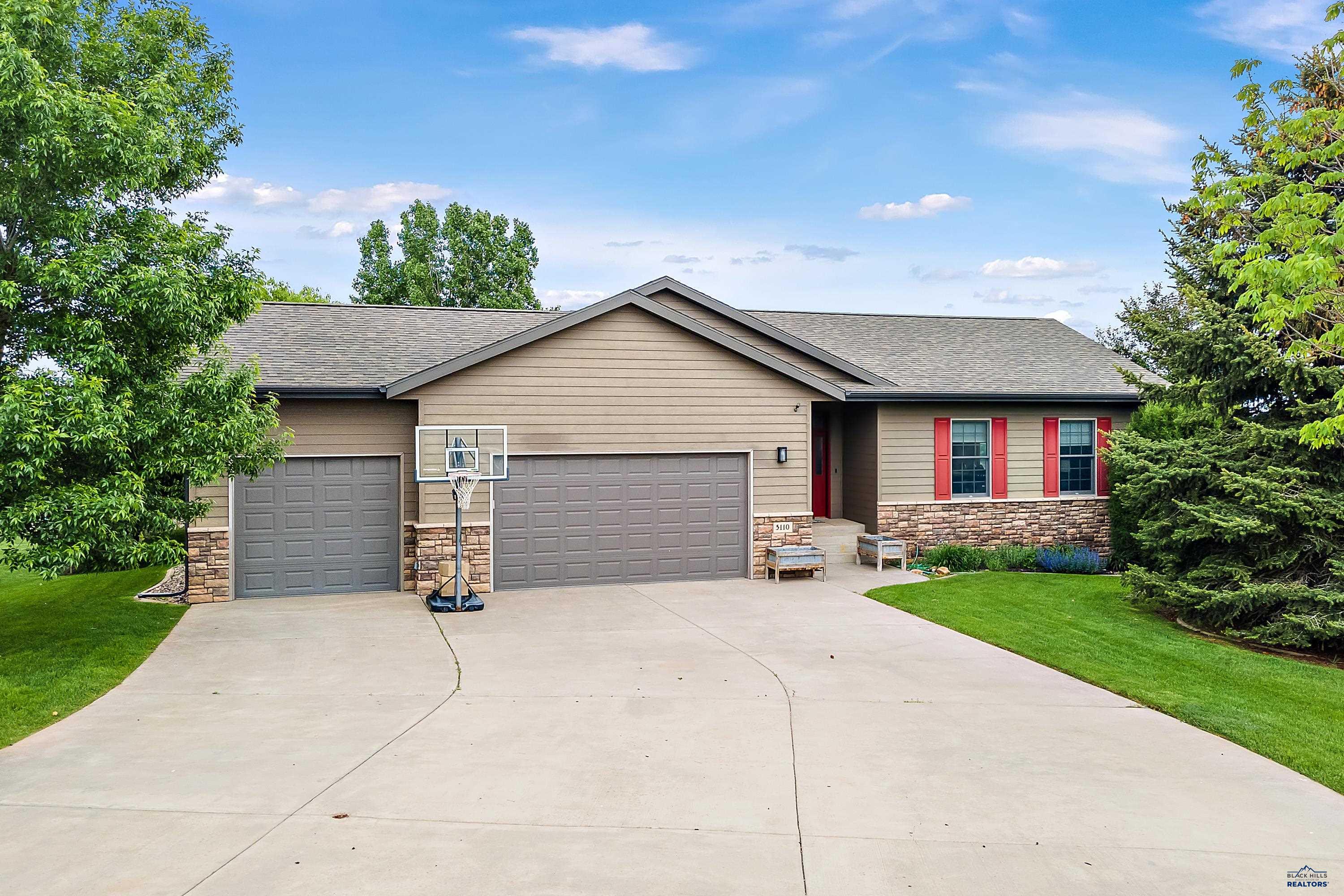 Listed by Jenni Brue, Keller Williams, 605-381-1055. Need bedrooms? This is your new home! Seven bedrooms complete this 4200+ square foot home! This home has been meticulously well cared for and for the first time ever is ready for new owners. It's nicely situated at the end of a cul-de-sac on a 1.31 acre lot in town! You will feel like you are in your own private park sitting on the back northeast deck overlooking the many mature trees & fantastic view of the city. Inside you will find an open concept of the living room, kitchen & large dining area, perfect for entertaining. There are three large bedrooms on the main level including the Master Suite with a vaulted ceiling, and picture window overlooking the backyard. Downstairs has an exceptional sized family room with gas fireplace which walks out to the patio. Four large bedrooms complete this level, all which have garden level windows. Laundry hookups available in the lower level as well as 10'x19' laundry room on the main floor.