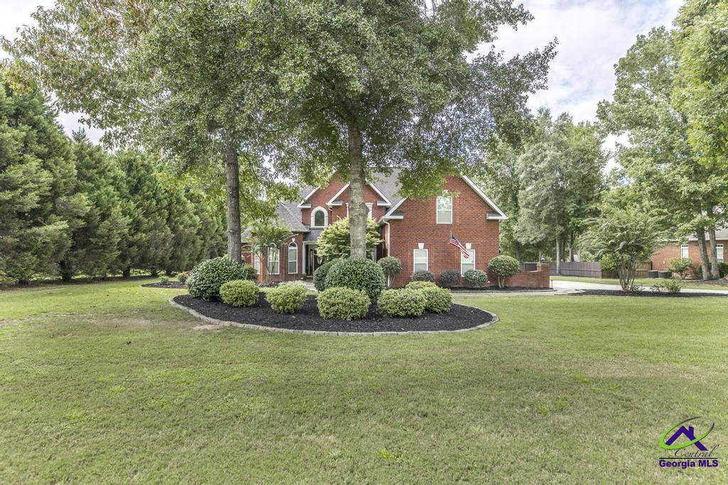This beautifully remodeled 5-bedroom, 4-bathroom home offers luxury living in one of Warner Robins’ most desirable neighborhoods. Situated on nearly an acre of fenced property, this spacious residence boasts an in-ground pool, a cozy pergola-covered patio, and a rare three-car garage.  Step inside to discover soaring double tray ceilings and a smart split-bedroom layout. The main level features a huge master suite with a spa-like bathroom, plus three additional bedrooms. Upstairs, you’ll find a second master suite with its own washer/dryer hookups—perfect for guests or multigenerational living.  Enjoy entertaining in the expansive dining area and newly renovated kitchen, complete with top-of-the-line stainless steel appliances. A full-size laundry room adds to the convenience.  Zoned for Bonaire Elementary, Bonaire Middle, and Veterans High, and located just minutes from Robins AFB, shopping, and dining—this home offers the perfect blend of comfort, style, and location.