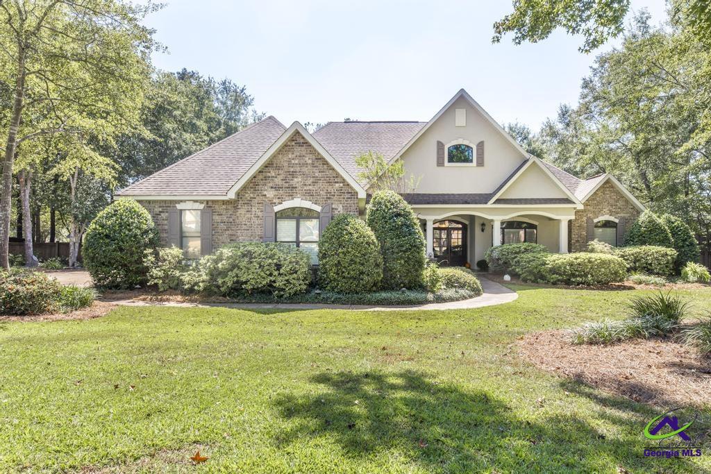 Exquisite 5BR/3BA custom residence on nearly an acre corner lot. Designed with timeless elegance, this home showcases two inviting living areas, each with its own fireplace, stunning stamped concrete floors, and custom built-ins. A chef-inspired kitchen offers abundant cabinetry, while the screened porch provides a serene retreat for year-round enjoyment. Possibly overshadowing all of the wonderful features is the 182 Sqft master closet with custom shelving.  This home will take your breath away!