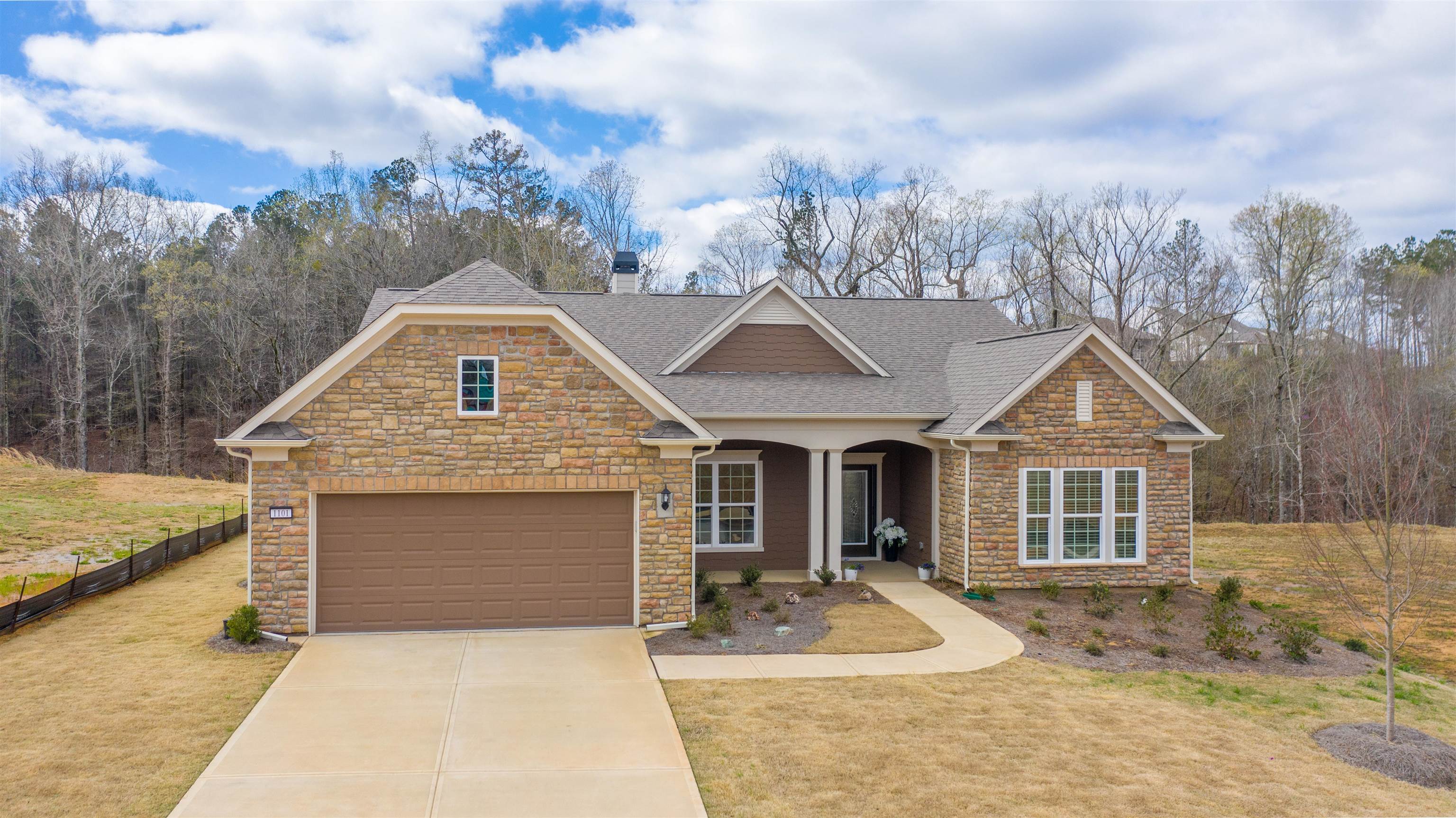 Beautifully Decorated Custom Built Home in the Del Webb community at Lake Oconee. This home is the Dunwoody plan and was purchased new in July, 2021. Some of the many upgraded features include the 4' garage extension, dual owner's suite, fireplace in the gathering room, master zero entry shower accessible for wheelchair, gorgeous sunroom, screened back porch, water softening system, full yard irrigation, under kitchen cabinet lighting and fans installed in the kitchen, gathering room, sunroom, bedroom, study and porch. A custom glass insert was installed in the front door and a retractable screen door was installed. Many additional upgrades were selected at the design center including upgraded stone, flooring, tile, paint, 5" baseboards and window casing to name a few.  Enjoy new home living without the wait of building.
