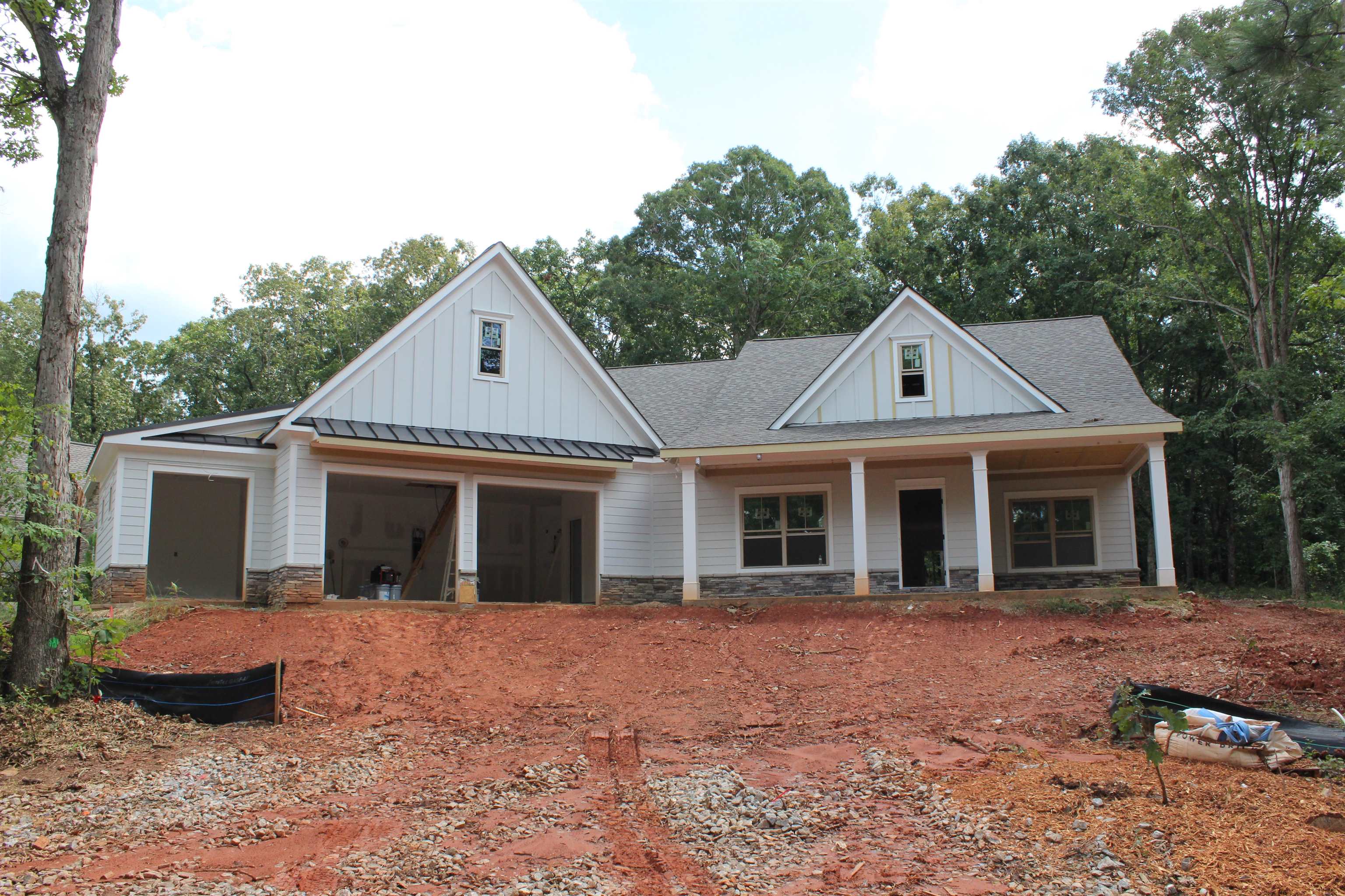 New construction in Parkside at Cuscowilla.  This 4 BR / 3.5 BA home is located on an elevated lot across the street a park with a pond.  The open modern floor plan flows from the kitchen into the living room with a large covered porch with and outdoor fireplace.  The master is on the main level along with an additional bedroom / suite.  There is an additional bedrooms with a shared bath upstairs. Features included granite countertops, hardwood floors, crown molding, and tiled baths.  Located only a short golf cart ride away from the Clubhouse, pool and boat docks.  a Cuscowilla Golf Membership is available.