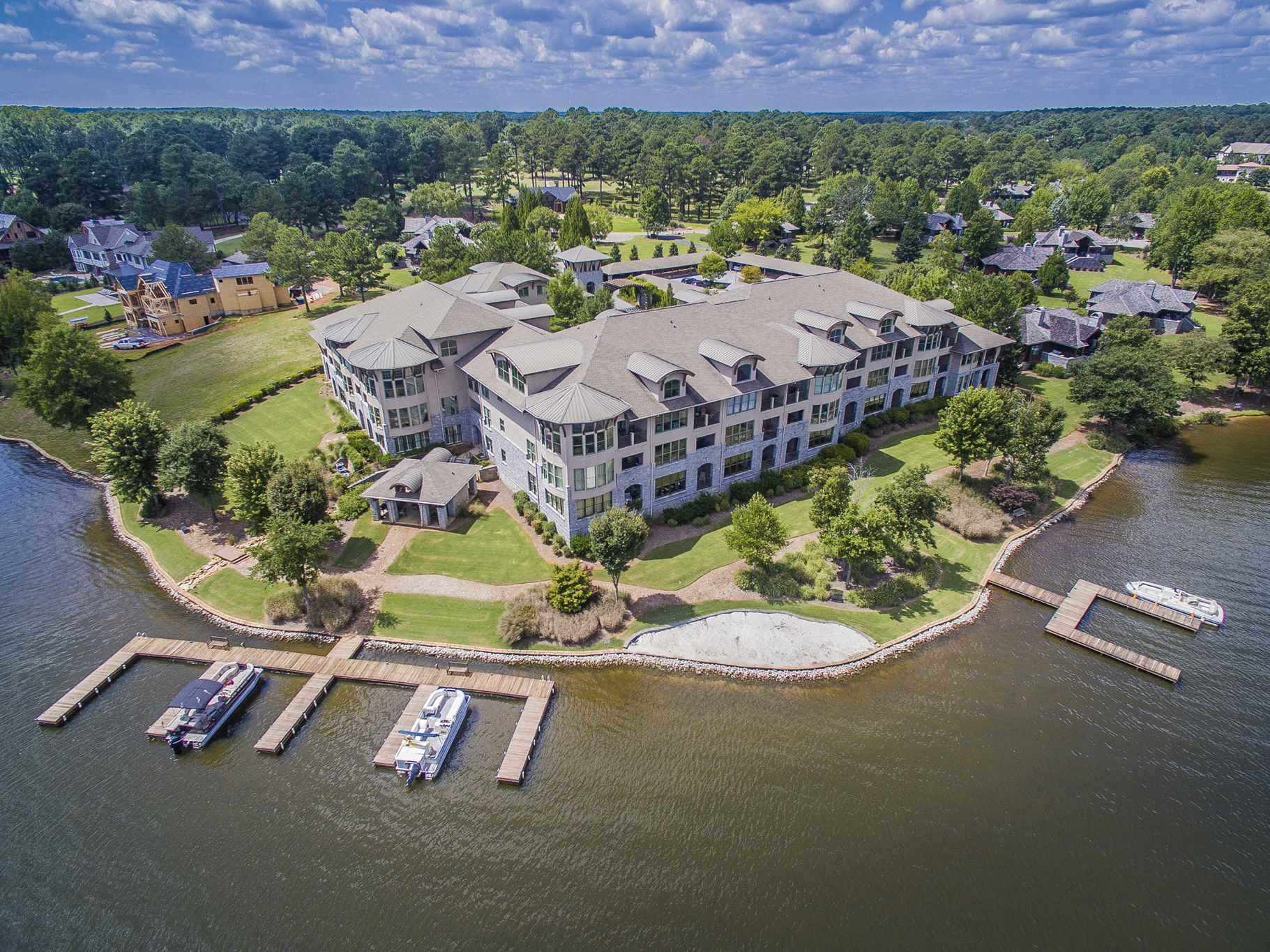 Lakefront Condo in Sojourn at Cuscowilla!  Enjoy the Main Lake and Golf views from your covered Lakeside porch.  This upgraded single level condo has 3 BR / 3 BA with granite counter tops, hardwood floors upgraded crown molding, high ceilings, recessed lighting, and a rustic ship lap accent wall.  The open floor plan flows from the kitchen, through the living room and to the Lake.  The master bedroom has a main Lake view, tiled baths with a separate shower and a walk-in closet.  There are 2 additional bedrooms and baths and a covered Lakeside porch with an upgraded see-through railing. Owners enjoy covered parking, a lakeside pavilion with boat docks, grills, and a restroom.  There is golf cart parking available and its only a short ride to the Clubhouse, swimming pool and Golf Course.  The furniture and a full Cuscowilla Golf Membership are available.  2022 Cuscowilla Master POA - $2,600 2022 Sojourn POA - $440.49 per month