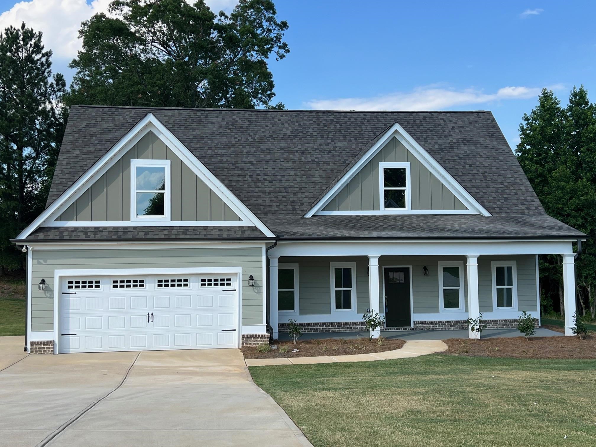 Craftsman-style house featuring a front yard, a covered porch