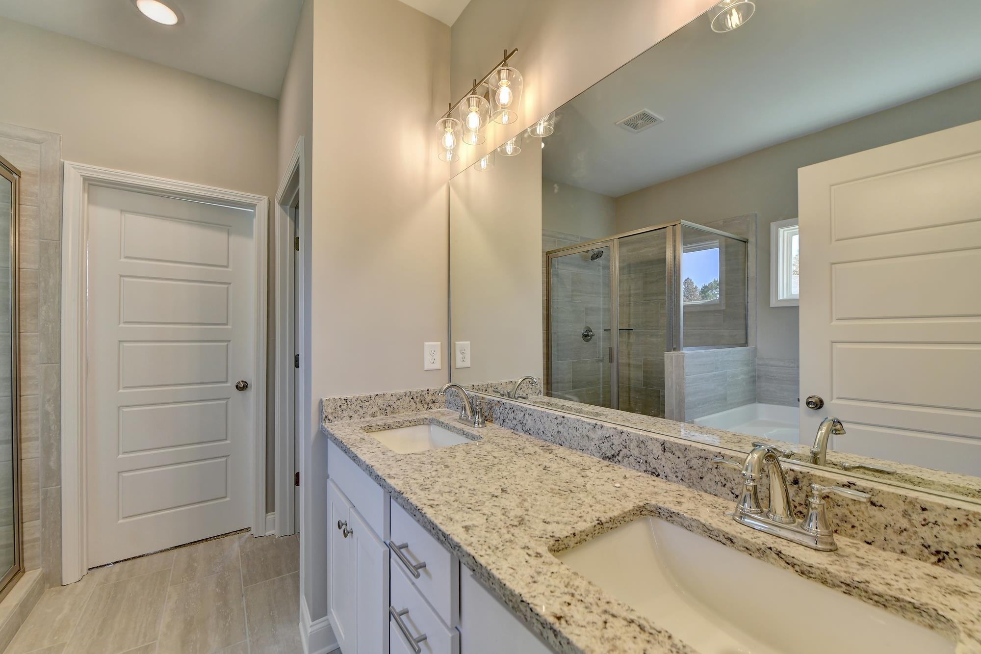 Master Bathroom with separate shower and tub and dual vanity