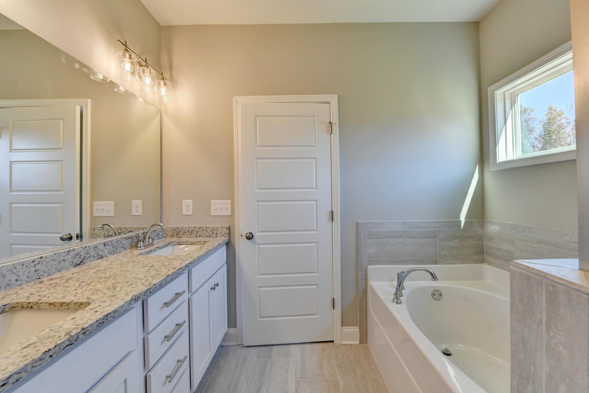 Master Bathroom with separate shower and tub and dual vanity