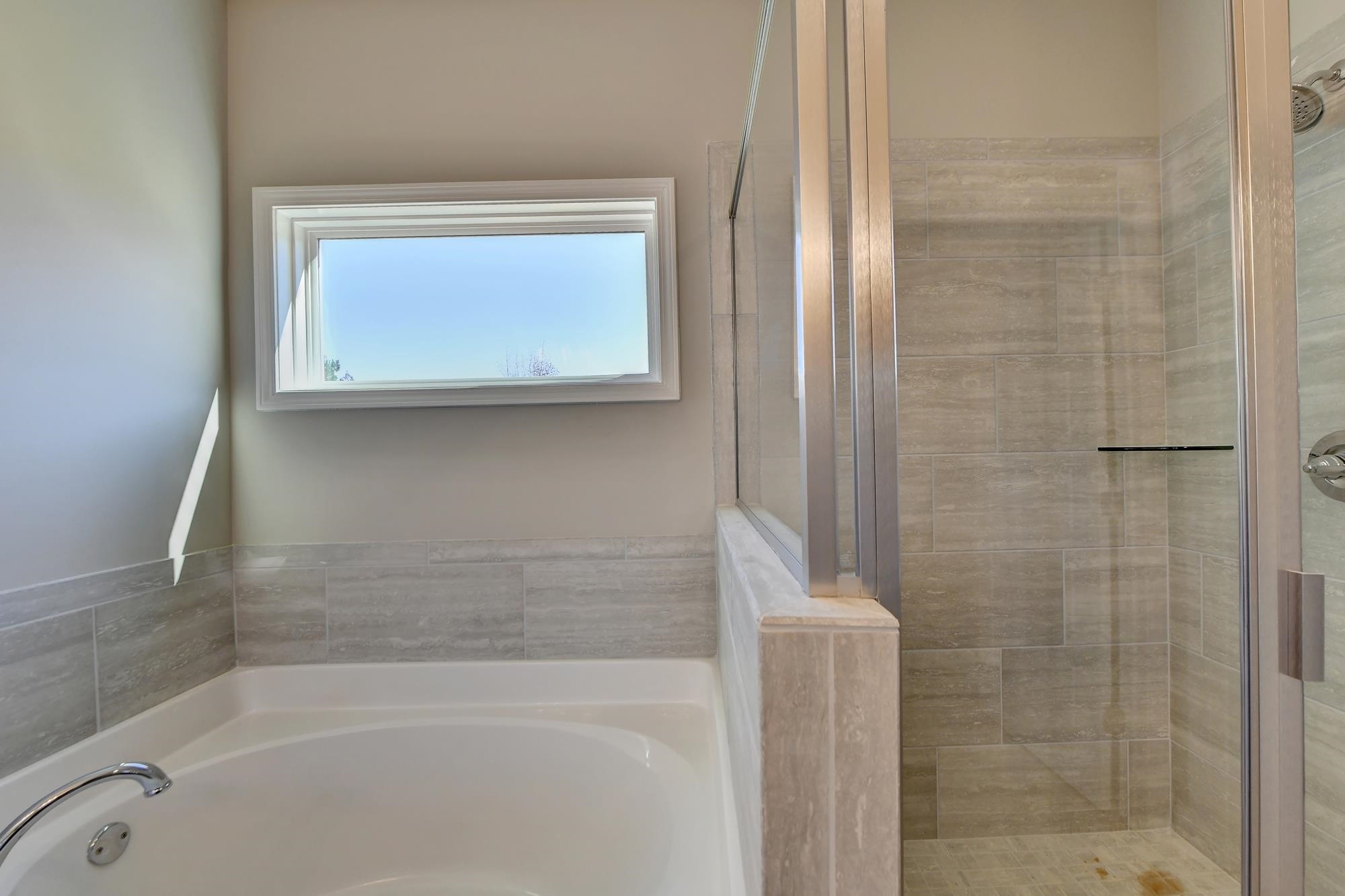 Master Bathroom with separate shower and tub and dual vanity