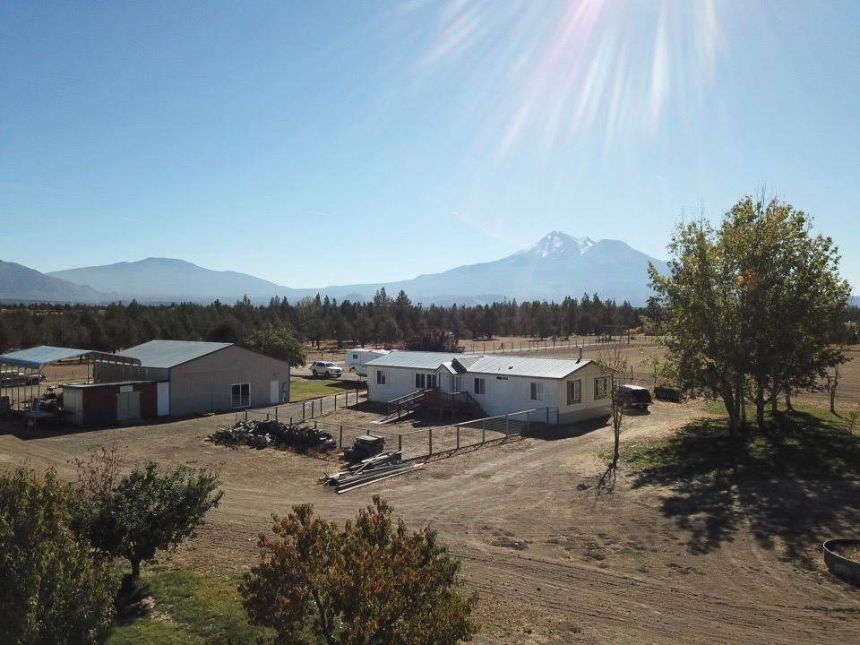 Located off of Hwy A12 in Montague lies this gem! Incredible views of Mount Shasta and the surrounding hills. This property has 5 completely flat useable acres that is fenced and cross fenced. A small barn with tack room ready for all of your animals. The home has 3 bedrooms, 2 bathrooms with Livingroom and family room. The home has had all new flooring installed in the last couple years. Other upgrades include new well pump in 2017, new heat pump and water heater in 2018. 2 carports are included with a large shop! Large enough to store all farming equipment and toys. Enjoy the peace and quiet this home has to offer.