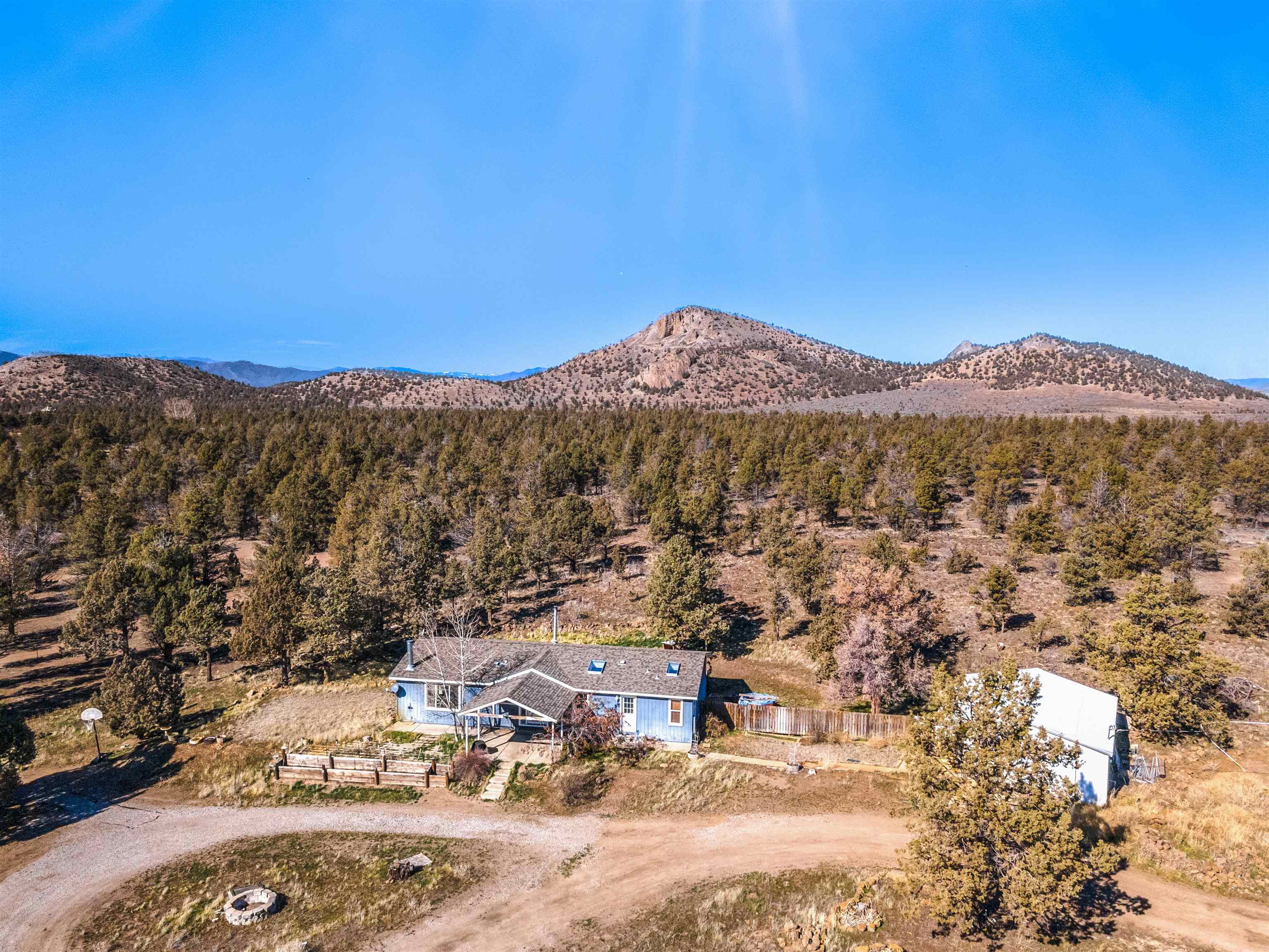 Bring your animals and enjoy simple living on this 10 acre ranch style home. As soon as you walk out the front door, you are greeted by Mt. Shasta's glory. The home has healthy living spaces with an open floor plan in the kitchen and living room, and another adjoining family room. The primary bedroom is on one side with a separate bathing tub and step in shower. The two other bedrooms open to the second family room. The property offers a detached two car garage, two separate carports, and abundant pens for your animals. Although located near all of life's needed facilities, the property is tucked away at the very end of a dirt road. You're sure to love the privacy this property grants!   * Note: The accuracy of the information provided is deemed reliable but is not guaranteed, is subject to change and should be independently verified.