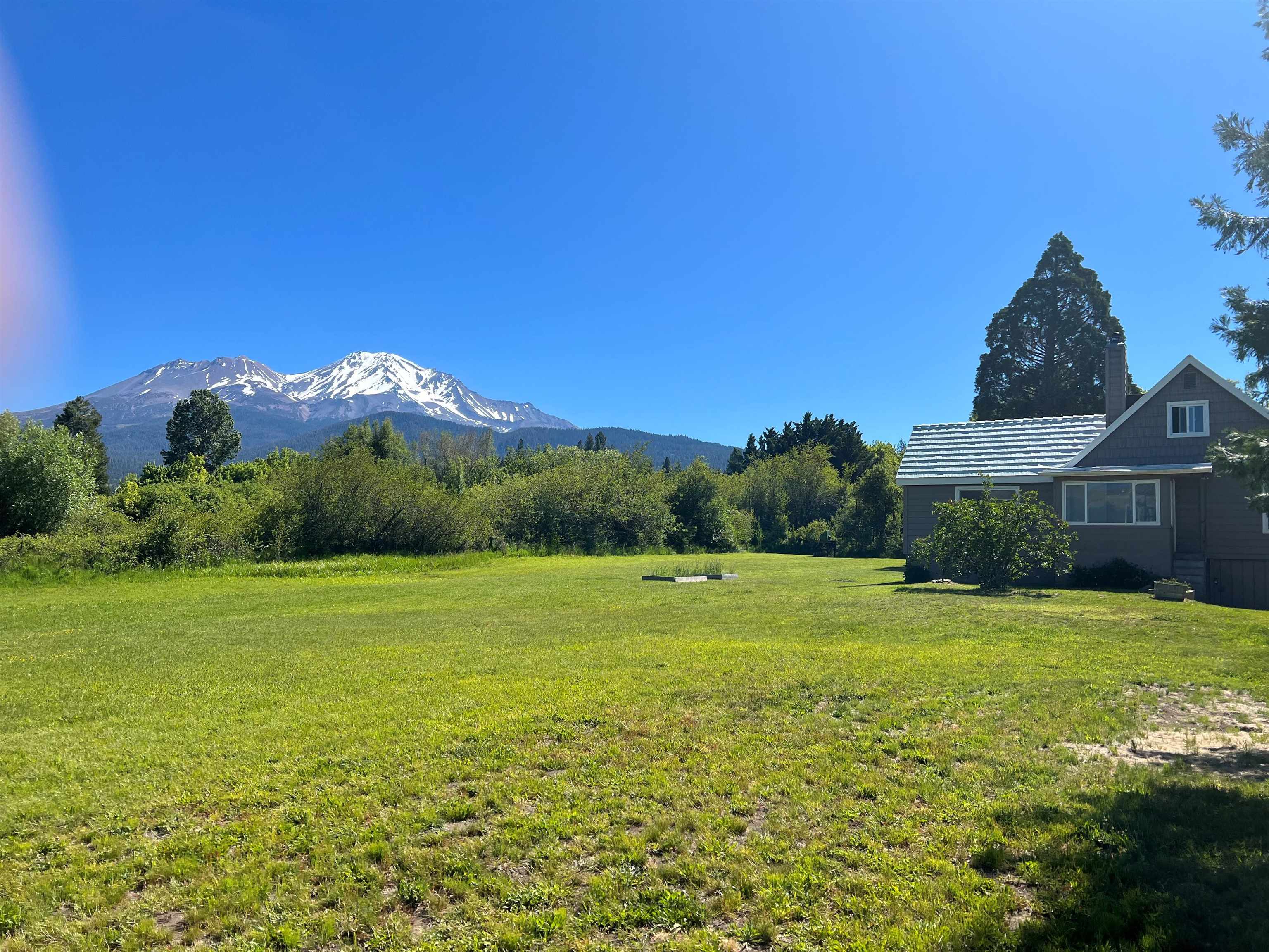 Location, location, location!  3 lots all zoned commercial with amazing views of both Mt. Shasta and the Eddy Mountains.  Just think of the opportunities these lots have to offer.  The house has been partially remodeled and features an updated kitchen and bathroom. The main living room is light and bright and open to the kitchen. The upstairs bedroom and living area features windows with views on both ends of the house. Large basement for storage with drive in underground garage.   Just minutes from Lake Siskiyou, Mt. Shasta Resort and Mt. Shasta Ski Park.  This amazing property is located in town and could make for a great home or income property.   Just think of the potential !!!!