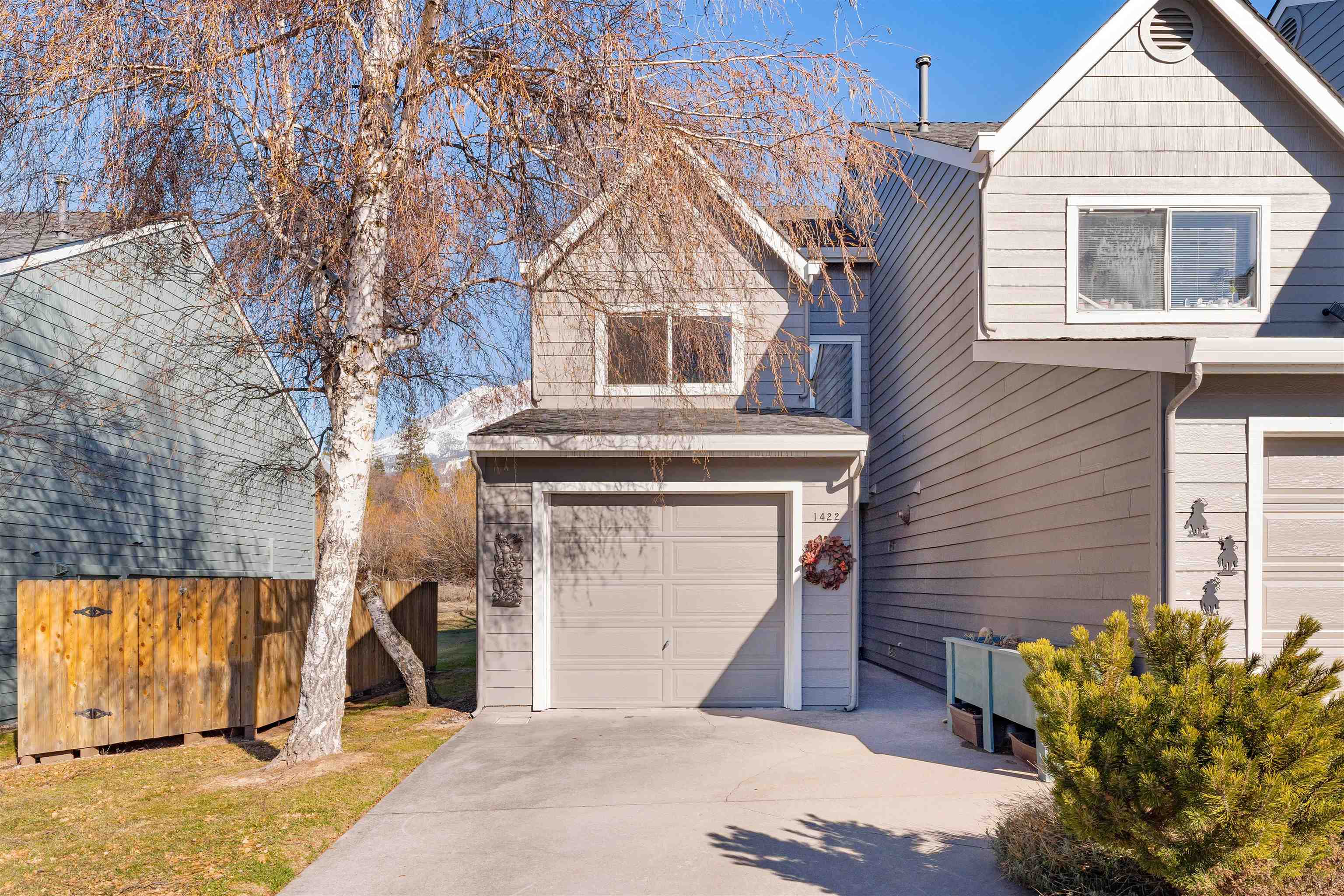 With a beautiful view of Mt. Shasta and surrounded by natural landscape with trails to City Park,  this stunning artfully designed remodeled home features a fabulous kitchen w/ stunning red dragon granite countertop, custom alder cabinets (built locally), floor to ceiling storage, undercounter lighting, lazy Susan corner cabinets, appliance garage, built-in microwave space, propane gas cooktop range/single electric oven, & tiled floors. Open floor plan offers a dining & living room w/ premium hickory hardwood floor,  ceiling fan & view of the outdoors facing spring Hill and Mount Shasta. As you exit the double French doors with inset mini blind panels, you will walk out onto the custom flagstone patio to enjoy the all-natural meadow & forest w/ no other townhomes or buildings visible. Large master bedroom (14 x 22) features double closet w/ sliding doors, extra storage above stairwell & a redwood balcony overlooking Mt. Shasta and the local natural area. Master bathroom sports heated floor w/programmable thermostat, built-in antique armoire for linen storage with hallway loading access, double basin Japanese sinks & custom cabinets matching armoire. Truly a one-of-a-kind find!!!