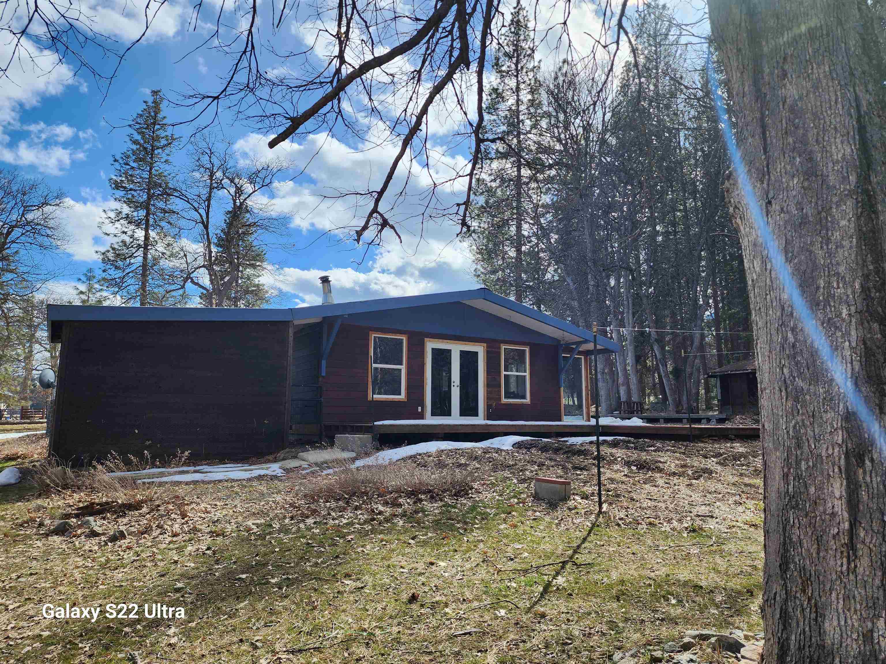 Charming cabin with seasonal  Alder and Sniktaw creeks flowing across property. If that's not enough water there are TWO good sized ponds with a resident duck family. Lots of windows allow natural light in and allows you to enjoy the beautiful creek and nearby mountains. Home is cute with renovated bathroom and an open floor plan and vaulted ceilings that make to space welcoming.. View is stunning of nearby mountain's and ranches. Perfect for a hiking , fishing or hunting retreat . Out buildings include a Octagon  BBQ gazebo with large deck for entertaining,  a good sized workshop , metal carport and a 2 car garage.  Located on a quiet street leading to Forest Service lands and Big Meadow trail head. According to owner hazard insurance is reasonable buyers to verify. Flood Cert is available  Seller is going to fix the wood pecker damage and give a reasonable carpet allowance.  All information is approximate and subject to change buyers to verify all aspects of the property.