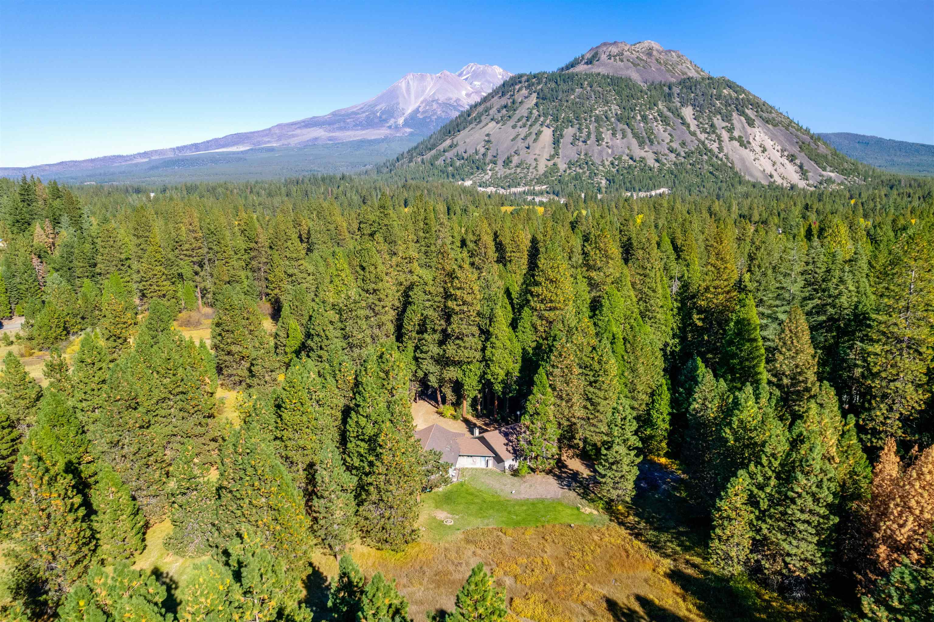 Welcome to this beautiful,well-cared for, custom built ranch style home,approx. 2900 sqft in Mt Shasta.The home is on 9 secluded acres, surrounded by wildlife, with big trees & meadows that offer serenity and relaxed mountain living.The home features a great room with vaulted ceilings and large view windows facing out over the meadow. The home also features a fireplace with an insert surrounded with stone, two spacious bedrooms plus an expansive master suite with a walk-in closet & jetted tub, an office with built in book shelves and a custom murphy queen bed, and an oversized utility room and a 4+ car garage. This property has the perfect setup for horses featuring a 2 bay barn with a tack room which opens to natural meadows. High speed internet is provided by StarLink and the home is wired for a whole house audio and alarm system.This home also features a new water heater as well as a new central heating and air conditioning system with all new insulated duct work & Wi-Fi Thermostat.The automatic sprinklers for lawn and garden are controlled via internet as well.