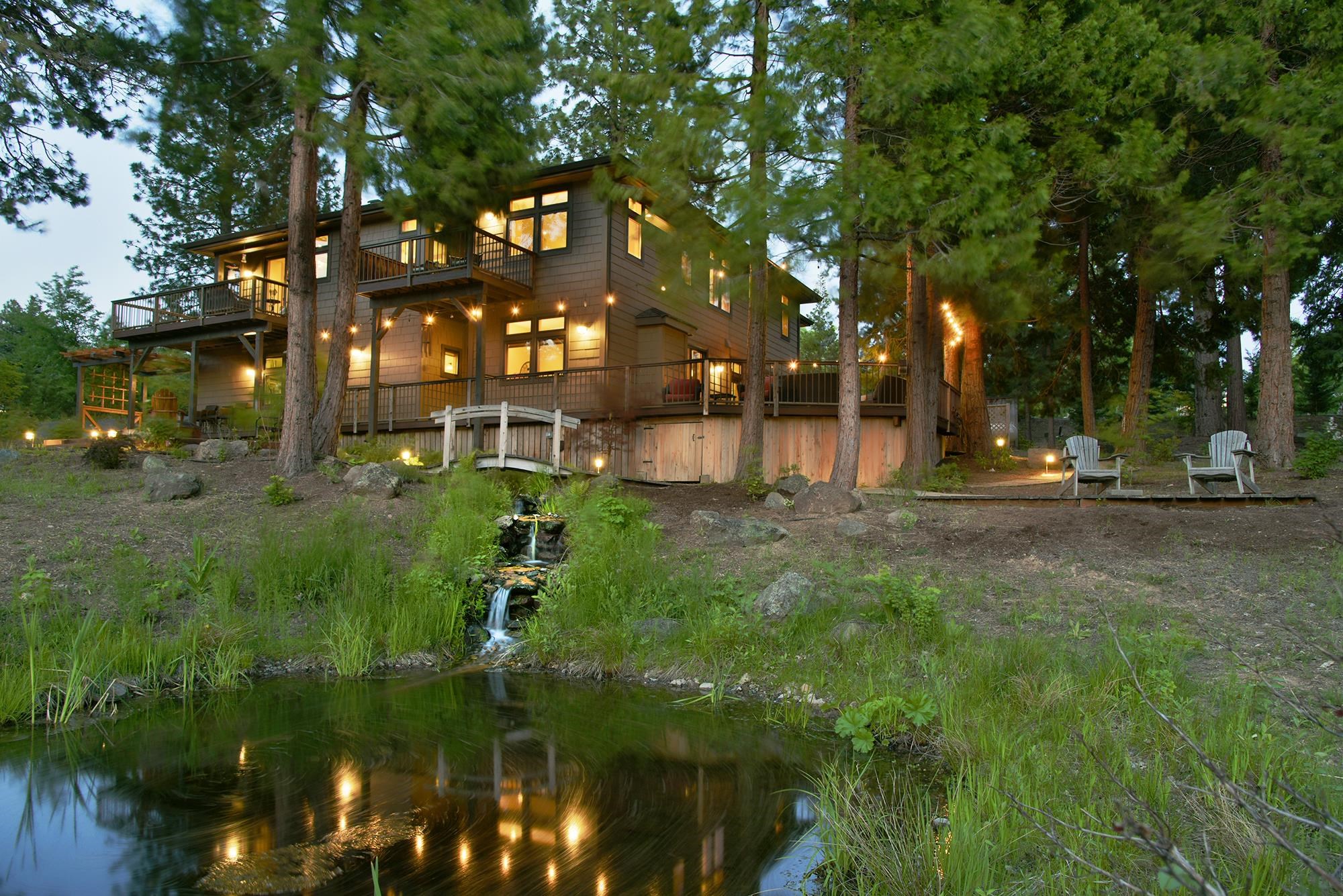 Gorgeous Mountain home on 2.61 acres of trees, fish pond, beautiful landscaping, waterfall and walking trails on the property! This gracious home offers superb attention to detail with premium architectural quality. Two living spaces: main has master bedroom, master bath and 2nd bedroom/office with full bath, views of Mt. Shasta from living, dining, kitchen and deck areas. 2nd level features 900 sqft guest/in-laws quarters with fireplace, kitchen, 1.5 bath and outdoor living space. High-end Rumford fireplace, Trey ceilings, cherry wood floors, maple cabinets, stone counters, tile backsplash w/ custom mural, and interior pine windows to name just a few amenities. Seller purchased adjacent lot in 2019 and selling original and adjacent as one. Property features walking trails, custom pond, walking bridge, water feature and extensive landscaping by Landscaper Design Contractor. Check out the custom entry gate and arbor. Seller also replaced the expansive decking with Elite Sylvania Eco-friendly wood alternative and planted Leland Cedar trees for more privacy. Walk to Lake, Golf resort and Restaurant...A must see! Call for appt now.