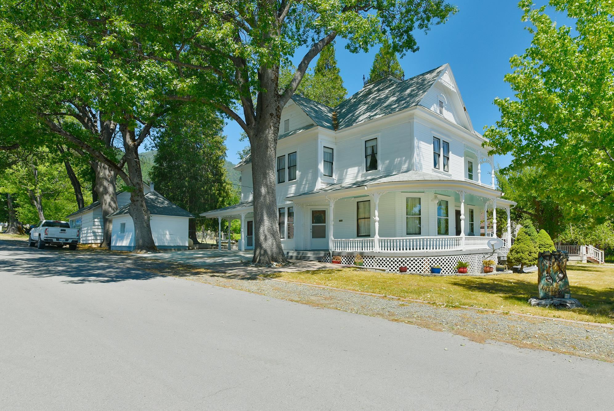 Glorious Victorian era home! Features include a large primary bedroom  on the main level with 4 bedrooms and bathroom on second level. County kitchen and large formal dining room. Large custom cement patio with built in BBQ and counters for outdoor cooking.  Bosh on demand water heater, ,gorgeous main level master bath with walk in closet, large tile shower & claw foot tub and dressing room.  This home has character and charm of the old days with a crows nest on the roof, covered wrap around porch, original wood work and details. Old fashioned root cellar provides ample storage for canned goods. Propane stove in the dining room is main heat source.  Most of the home has original wood floors that have been keep in great condition and owners believe the same floors are under the carpet in the upstairs bedrooms. Security cameras are in use  Huge back yard  and garden area. All information is approximate and subject to change