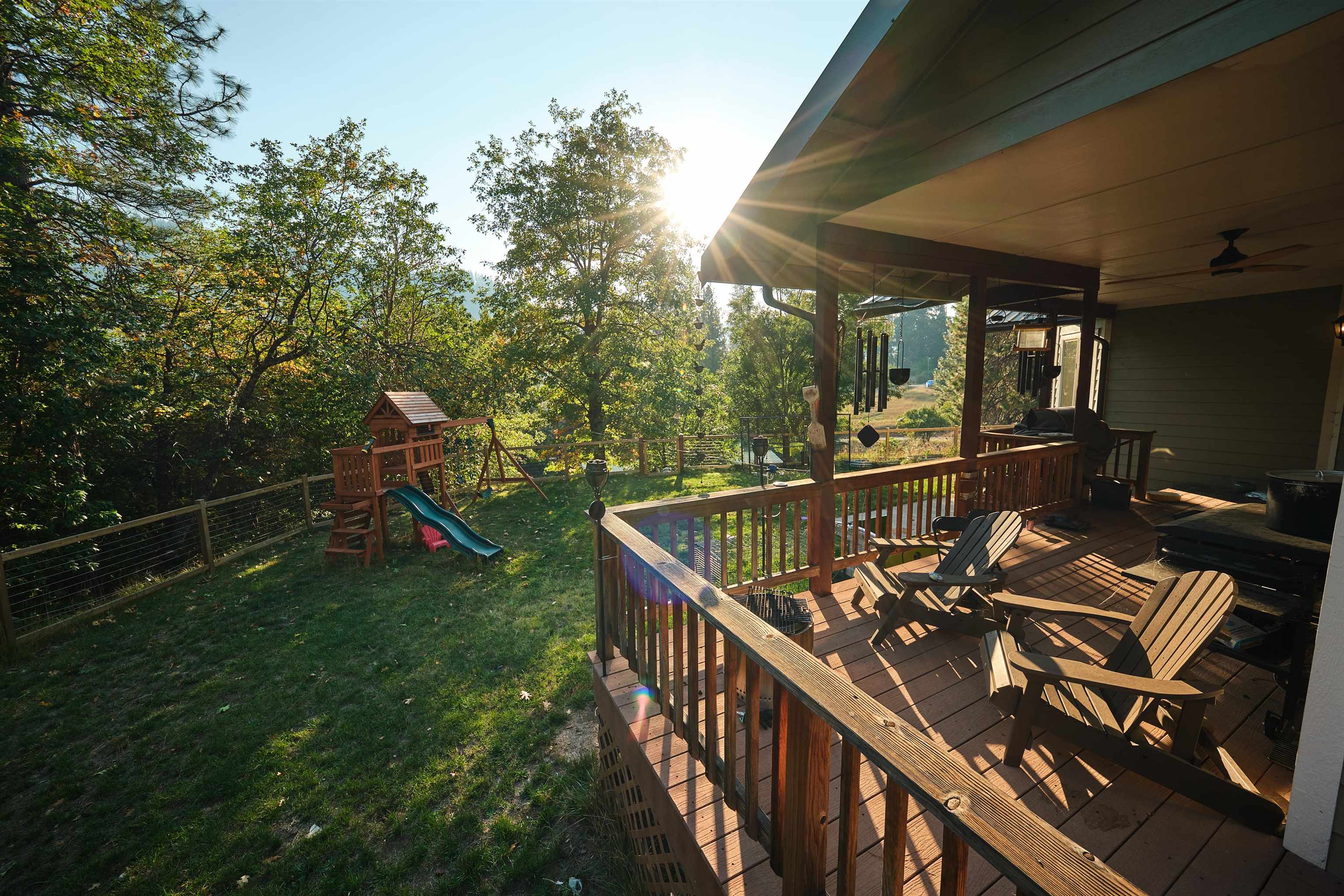 Beautiful Country Estate up Elk Creek a Custom 3 bedroom/2 bath Built Home on nearly 10 Acres w/ a Ginormous workshop the size of a very large house. The house itself has an open floor plan with gorgeous views overlooking the wrap around deck with jacuzzi under the stars making it a pleasure to live and entertain. Entertaining is made easy with a kitchen designed by a chef, adding value to the home with specially made hickory cabinets, Viking Professional stainless steel appliances, double convection ovens, granite countertops, and an island equipped with electricity, a Viking propane stovetop and hood that opens to the vaulted Cedar ceiling & living area with picturesque sliding glass doors to the open deck, with cedar railing, that hug the house. Dining and breakfast area have huge framed hickory windows overlooking the meadow with lots of nice details and natural light! The Master ensuite has a huge walk in closet, an incredible bath with gorgeous stand alone soaking tub and walk-in shower, with remaining beds on the opposite side of the house; perfect for guest and/or children. The fire resistant siding and metal roof provides additional fire safety. Pigs & Ducks not included.