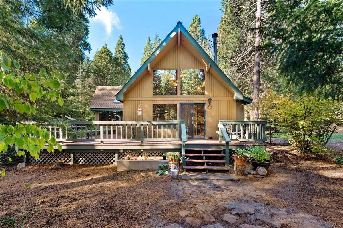 Beautiful country home on the outskirts of Mt. Shasta, sits this custom cedar home on 0.82 acres. Vaulted ceilings, picture windows, and sky lights give this unique home an open warm, natural light feeling.  The house sports 3 bedrooms 2 and 1/2 bath with the primary bedroom on the first floor. Laundry room is located off the kitchen.  Kitchen has tile flooring, custom cabinets, island with range, stainless steel appliances that open to the very bright living room. Other features include forced air heat and A/C with a wood stove,  a beautiful deck out the sliding glass door that leads you to a very private setting. The 2-car garage offers an extra bonus room off the back deck and opens to an amazing back yard with a seasonal creek, lots of trees and privacy for your outdoor entertaining.