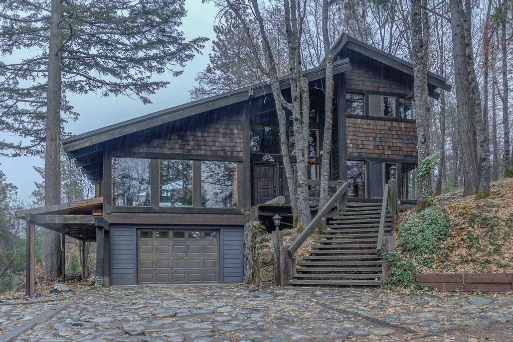 Check out this private, custom built Weed home on 9.4 acres! 1,934 square feet, 4 bedrooms and 2 bathrooms. Built by the current owners the 16 foot high ceilinged entry leads you into a house that has many custom features. The large living room is banked with windows that provide light, warmth and beauty. The living room features vaulted ceilings, large cozy window seat, freestanding circle fireplace, sliding glass door to the new deck, stained glass window and a fabulous Mt. Shasta View.  The U-shaped kitchen lends to an efficient use of space with custom cabinets, tile counters, eating bar, pantry, stove top, oven, trash compactor and dishwasher.  The dining area open to kitchen has a custom wood bench and wood stove.  The upstairs bedrooms have new carpet, multiple windows, custom wood features and 16 foot high ceilings. New water heater and pressure tank. Garden area and shed for storage. UOB Disk Golf Course borders property.