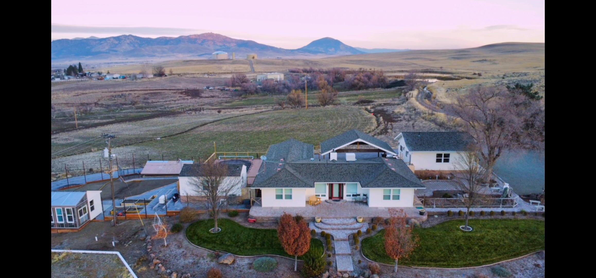 Beautiful country home on top of a hill W/ commanding views. 8+ acres with 360* views of Shasta Valley, Mt Shasta the Eddys and Black Butte, located ¼ mi East of Montague Proper.  Remodeled in 2011 again in 2019. This home offers 3 bedrooms, (one currently used as an office) and 2 full baths. The custom kitchen is designed to entertain, and it truly flows. SS appliances with granite countertops. Center island is 5' x11' includes a second sink.  The living room has a wall devoted to windows for ever changing views of Mt Shasta, a fireplace with insert to cozy up to, ak floors. The primary bedroom has walk in closets with his and her built ins, a beautiful shower for two, wood floors and alder ceiling. On the west side is the pool area, the pool is 15x30 the pool house with the deck and a fence surrounding it all.  Below the pool area is a fenced in deer proof back yard (fencing panels to be installed) with 16x16 greenhouse and hobby shed and large dog kennel. Below the yard is a 4 stall 40x30 metal barn with power, water and concrete center floor. Arena with attached runway to pasture.  Two 16x16 animal shelter. Another dwelling/ Studio w/ full bath, kitchen and mini split system.