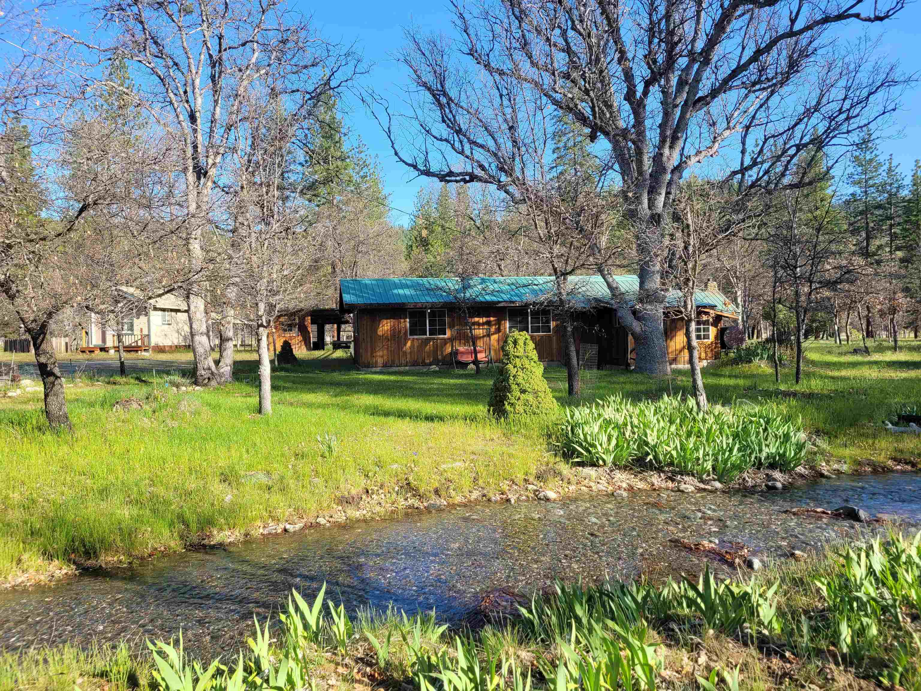 Escape the city and enjoy this Scott Valley home on almost 10 acres. This retreat has mountain views, trees, irrigation ditch (no water rights) and plentiful wildlife. This single level cabin style 3 bedroom home has been partially remodeled and updated over the years including a recent bathroom update, new flooring in kitchen and interior paint. Has fiber optics for fast speed internet. Has a detached Bunkhouse with a large attached carport. Be more self-sufficient with the organic garden with greenhouse, some fruit trees and a chicken coop. There is a 10 gpm well drilled in 2015 and the system utilizes the old water storage tank for efficiency. Nice neighborhood and centrally located in Scott Valley. Move in ready. By Appointment only to Pre-qualified Buyers. NOTE: The accuracy of the information provided is deemed reliable but is not guaranteed, is subject to change and should be independently verified.
