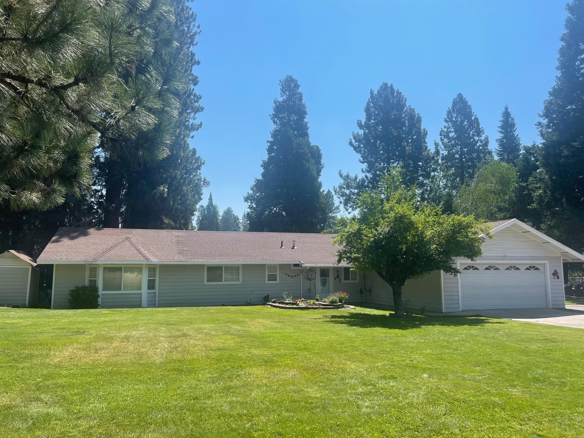 Spacious Country Home. This 2232sqft ranch style home is located in a great neighborhood within walking distance of all that downtown Mt Shasta has to offer. The large, open concept living area consists of the living room, a dining area and kitchen. The kitchen features granite counter tops, an eat at island, custom cabinets and recessed lighting. There is a wood stove, a Monitor heater and a newly installed Mini Split system to keep you warm in the winter and cool in the summer. With 4 bedrooms and 3 bathrooms there is plenty of room for the whole family. A 5th room is currently being used as a game room- this flexible space can be used as a family room, den/office, or bedroom dependent on your needs. The 1-acre parcel is lovingly landscaped. There is a gorgeous lawn with auto sprinklers, flower beds, evergreens, deciduous trees, perennials, and a greenhouse. The large back patio gives you plenty of outdoor livings space. The attached 2-car garage has lots of built in storage and a separate utility/laundry room. New roof in 2023. There is also a bonus workshop/detached 1-car garage. Call to schedule your private showing today!