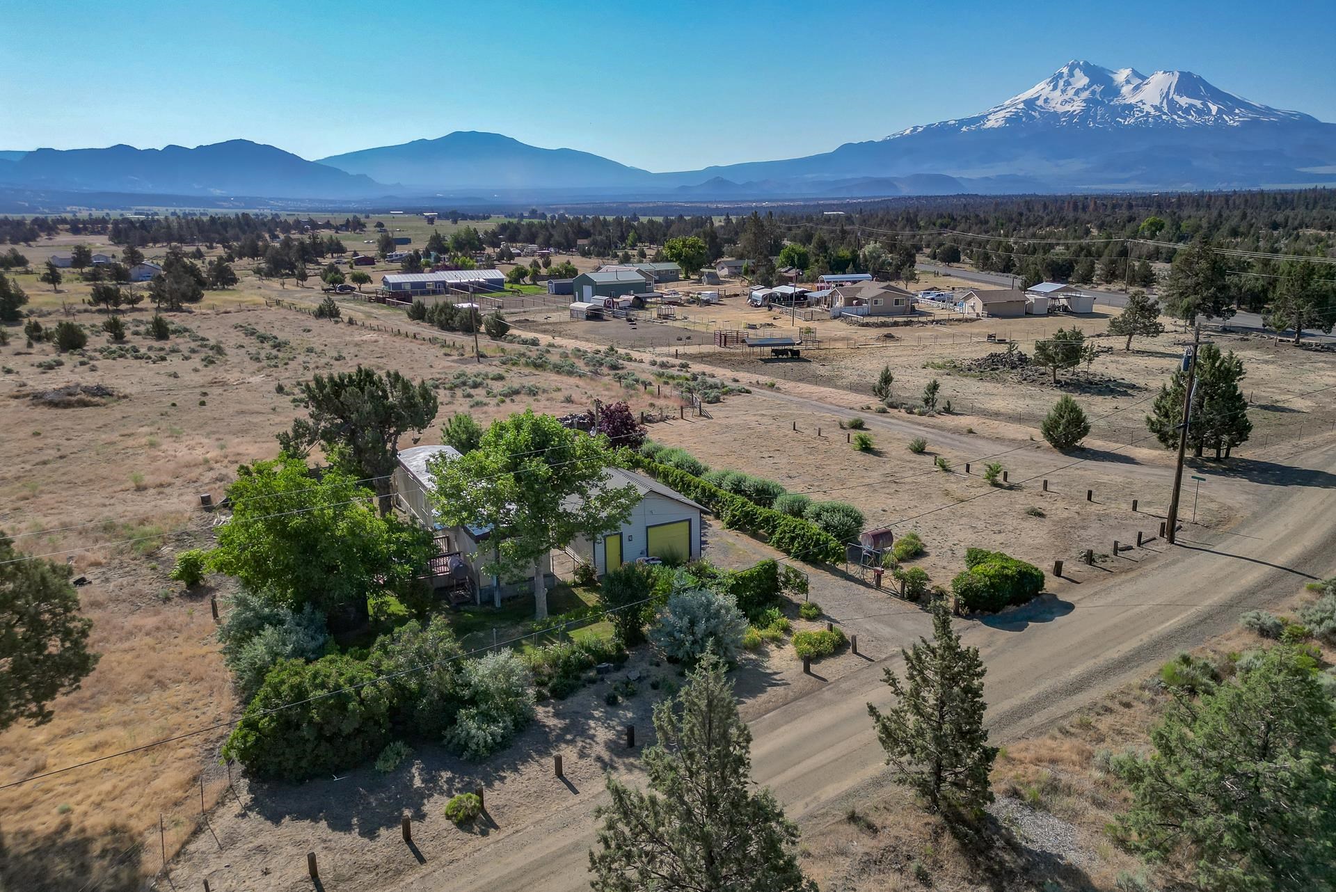 Welcome to 8236 Modoc Rd in Big Springs—a rare oasis offering the perfect blend of comfort, functionality, and stunning natural beauty. This beautifully updated manufactured home is nestled on a lush, private lot with mature landscaping, creating a serene, park-like atmosphere. Enjoy breathtaking views of Mt. Shasta and the surrounding mountains from your own backyard while relaxing in the peaceful country setting. Inside, updates bring clean and cozy feel, making the space both private and inviting. Outside, a huge detached garage and shop provide endless possibilities for hobbies, storage, or work, and the property is horse-ready, ideal for those seeking a rural lifestyle with room to roam. Whether you're dreaming of a hobby farm, a peaceful retreat, or a place to put down roots, this property offers a unique opportunity to live surrounded by nature without sacrificing comfort or convenience. Come and see!