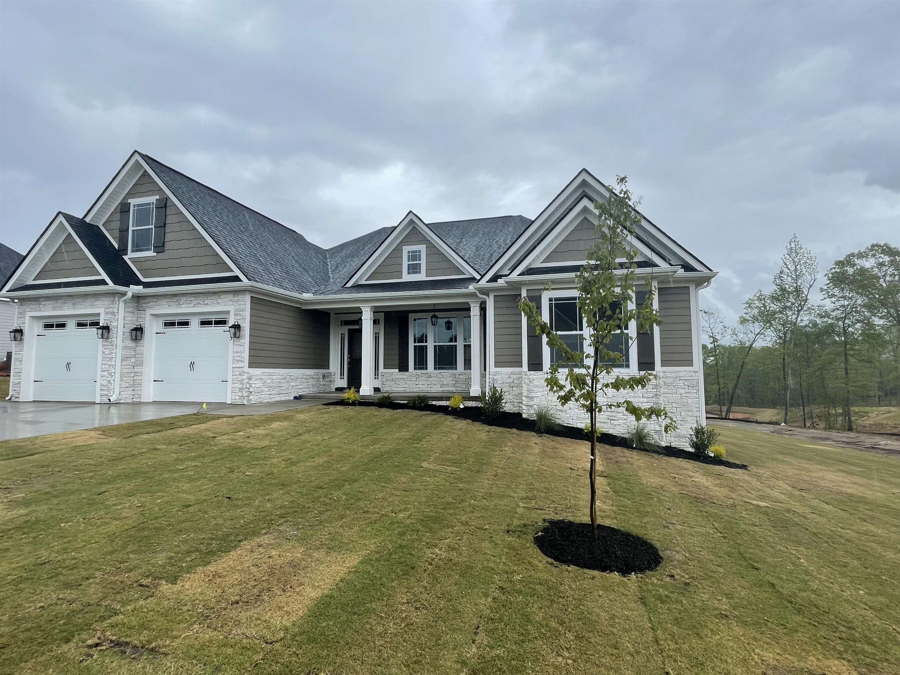 Brand new home and one of this builder's largest floor plans. Nestled in desirable Travelers Rest! Located on a cul-de-sac. Quality built, this luxury community features large lots, peek mountain and wooded views! Just 2 miles to downtown Travelers Rest and an easy drive to downtown Greenville. The Mayfair Elite is an open concept home featuring 4 bedrooms, 3 full bathrooms, office/study, large walk-in pantry, and large kitchen with extended cabinets & island.  Granite counters + breakfast nook. This floorplan includes two covered decks plus an expansive rear deck for entertaining.  Standard features in this home and in the community include concrete plank and stone exterior, architectural shingles, soffit exterior lighting, nine to 12 foot ceilings, crown molding with rope lighting in the master, living and dining rooms, large tiled double-headed shower in primary bathroom, separate tub, dual sinks, electric water heater, and more! Make one of many homes available in this community yours!