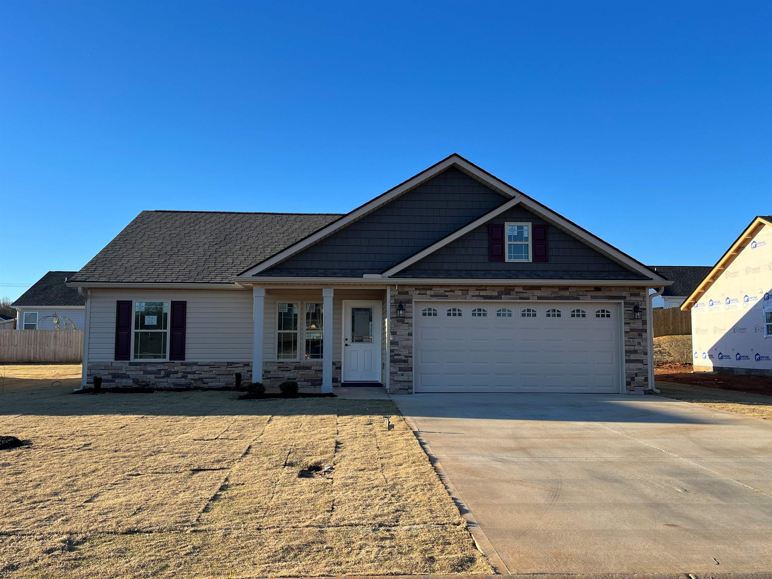 This is the SAXON, an open split floorplan with walk in laundry, half stone fireplace, upgraded flooring in living room, granite countertops, gas fireplace, and a 12x12 back patio. Located in the NEW Elliott Park community in Lyman just minutes from Spartanburg and Greenville. Call today for more info!