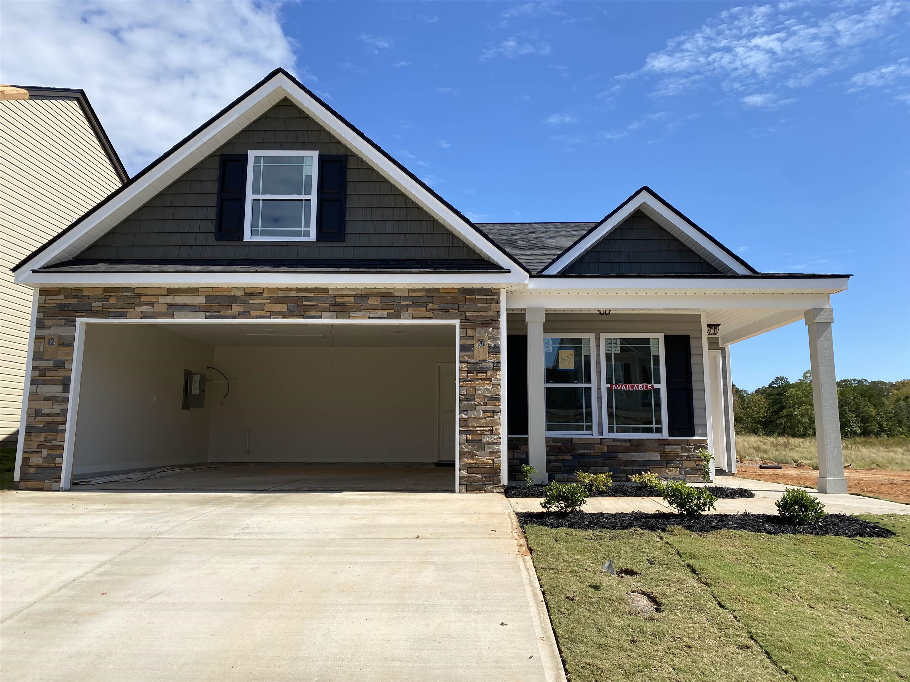 The CLIFTON plan has a spacious open living area and split bedrooms. Granite countertops, crown molding with rope lighting, and many more features included. Out back is a large covered patio. Lot 607