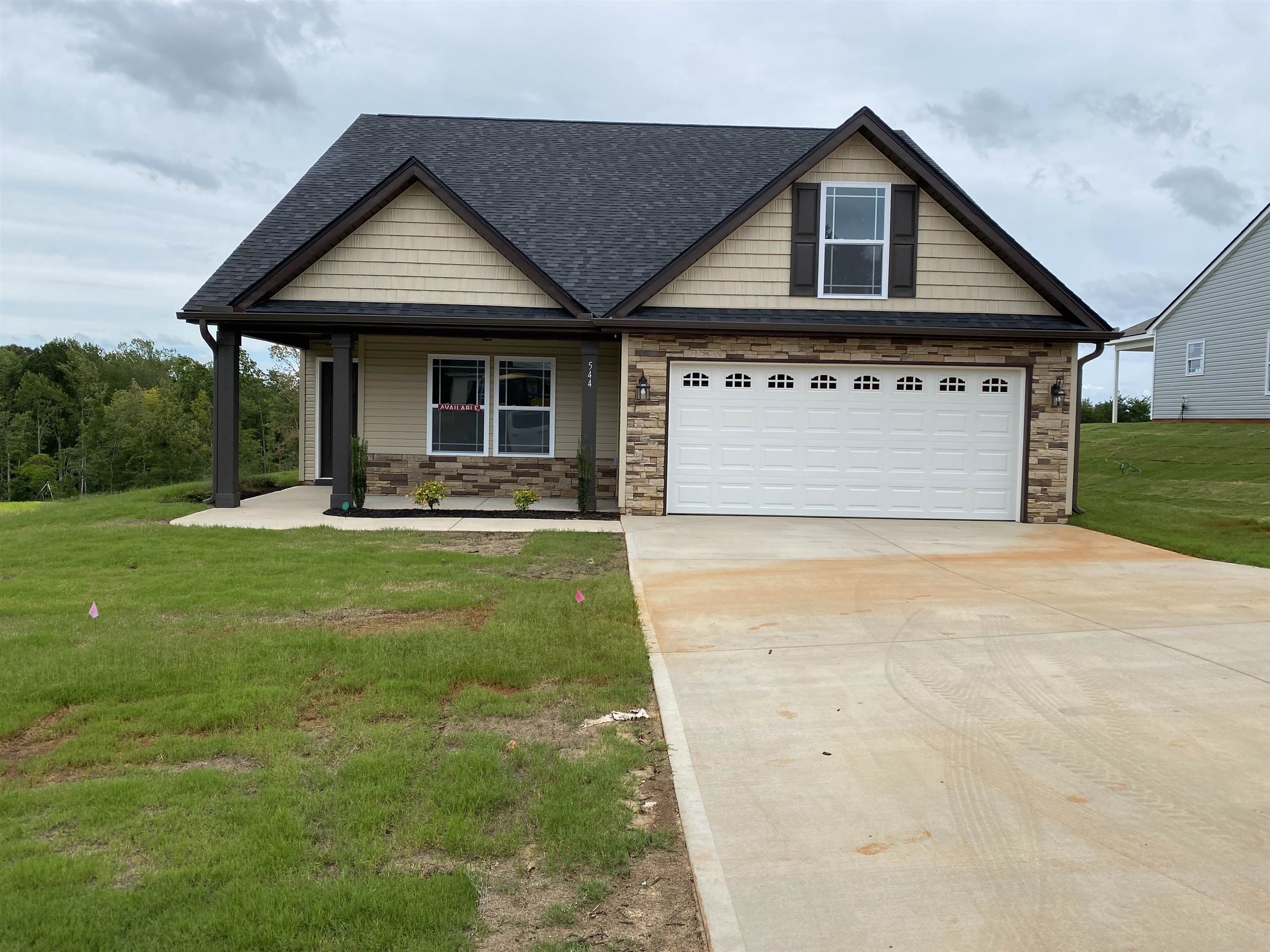 The FERNWOOD plan with a SUNROOM and covered patio. The large open living area features LVP flooring, a gas log fireplace, and the kitchen includes granite countertops. Crown molding with rope lighting, chair rail, and other included features make the home stand out. Out back is a large covered porch overlooking the huge yard. Closing costs/interest rate assistance are available when using preferred lender and attorney. MOVE-IN PACKAGE INCLUDED: BLINDS AND REFRIGERATOR