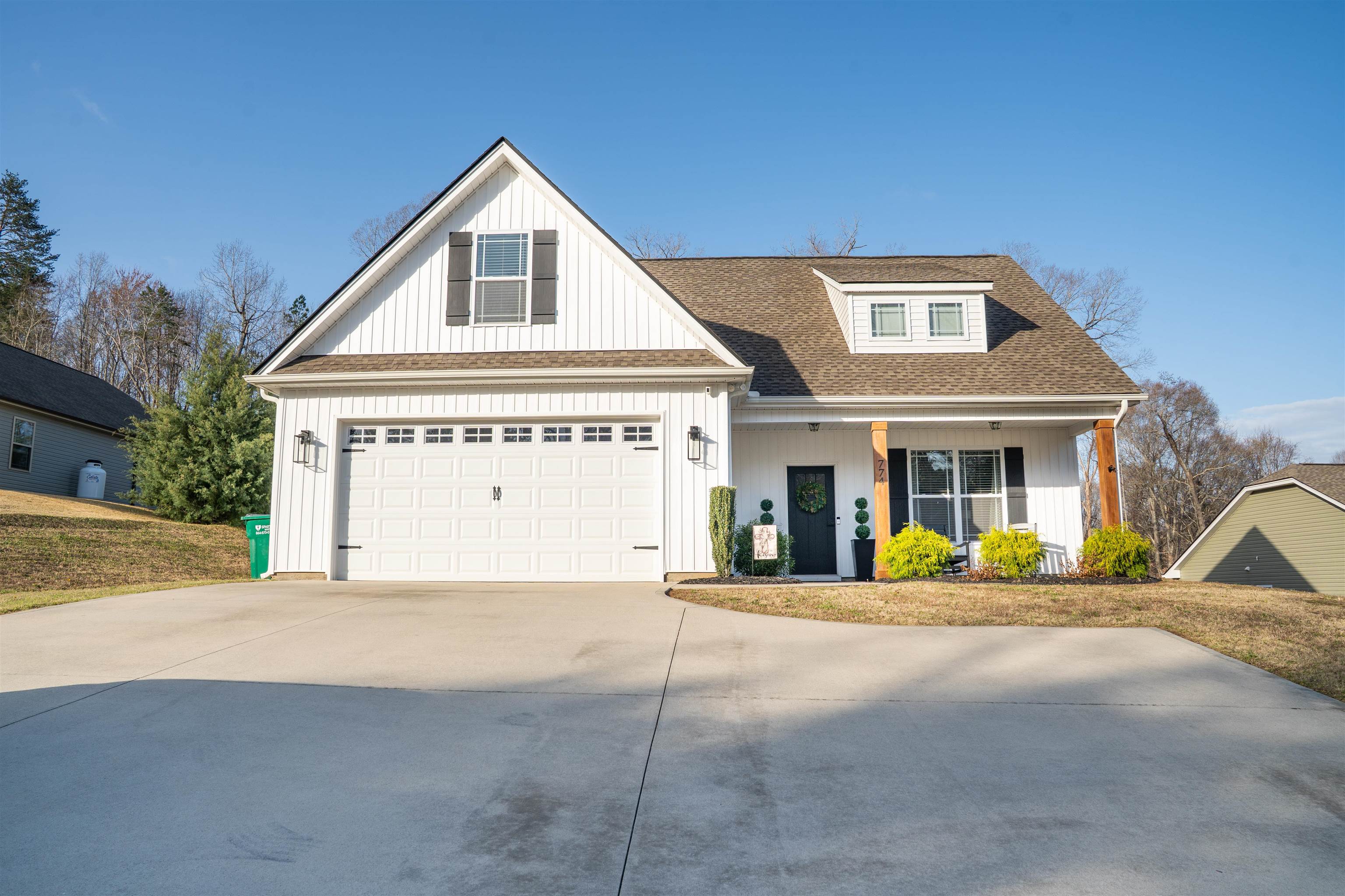 Welcome to 774 Old Canaan Road, a charming farmhouse-style home built in 2020, offering modern amenities and a classic appeal. This spacious residence features three bedrooms, two and a half bathrooms, and a versatile flex room. The main level boasts a generous living room with a gas log fireplace. The kitchen features granite countertops, stainless steel appliances, and seamlessly connects to the dining room for easy entertaining. The primary bedroom on the main floor offers two walk-in closets and a bathroom with double vanity and granite countertops. Upstairs, you will find two additional bedrooms, a full bathroom, a flex room, and ample storage space with multiple closets and two walk-in attic areas. Situated on over half an acre, the property features a classy fenced in backyard and a covered back patio. Located less than 10 minutes from downtown Spartanburg, this home combines rural tranquility with urban convenience. No HOA!