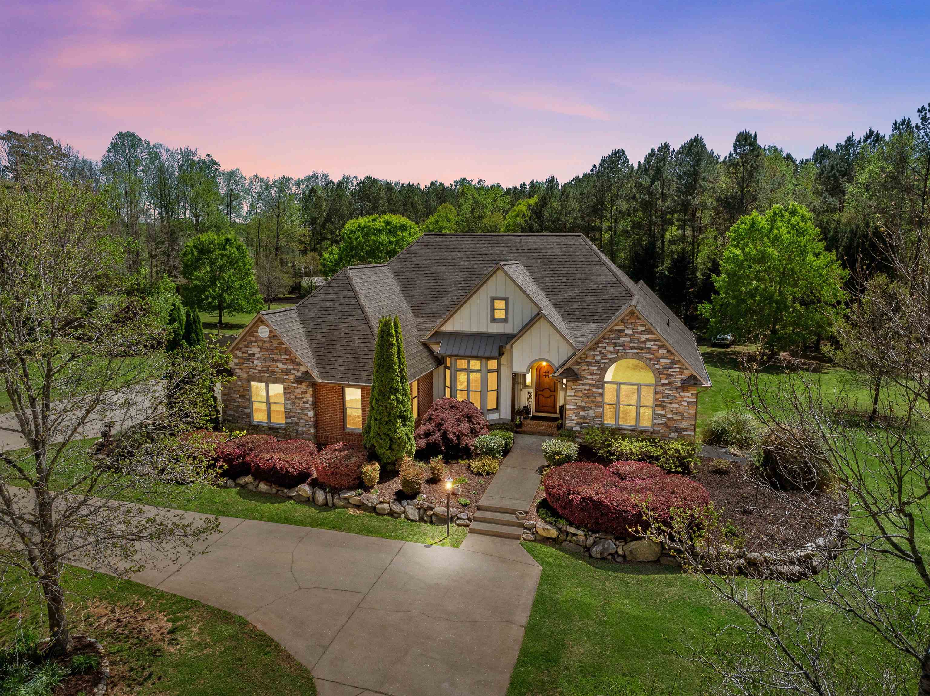 Custom-Built Home on 5.8+/- Acres in Cane Creek Subdivision Welcome to 255 Cane Creek Way—a meticulously maintained custom-built home nestled on nearly 6 acres in the highly sought-after Cane Creek community. Surrounded by natural beauty and upscale landscaping, this property offers peaceful country living with the convenience of being in Campobello city limits and within walking distance to Landrum High School. The striking exterior showcases stone, brick, and hardieboard siding, accented by unique architectural details including a metal roof feature and an arched front door with a peek-out window. A circular driveway with side parking and garage entry ensures ample space for guests and everyday use. Step inside to warm-toned hardwood flooring, extensive crown molding, and elegant finishes throughout. The inviting foyer opens to a bay-windowed dining room in a calming shade of blue and a spacious living room with a gas log fireplace framed in beautiful stonework. French doors flanked by 2 windows bring in natural light and lead to the covered back porch. A dedicated home office with vaulted ceilings and park-like views offers a flexible space to suit your lifestyle. The gourmet kitchen is a chef’s dream with a gas double oven, 6-burner gas cooktop, stainless hood, farmhouse sink, custom cabinetry with smoked glass doors, under-cabinet lighting, and a breakfast area that flows to the deck. The primary suite is a serene retreat featuring private porch access, six large windows, and a spacious en-suite bath with walk-in closet, shower, double vanities, and a bench seat. Two additional bedrooms share a well-appointed bathroom with a private toilet and tub area. The large laundry room includes storage cabinetry, a utility sink, and a custom sink cover for extra workspace or party prep. The walk-out basement offers a world of possibilities with partially finished spaces, including a bathroom with fixtures already in place. There is 2635 square feet of unfinished space in the basement. Framed rooms are ready for your dream layout—think rec room, guest suite, or workshop. Double doors provide easy access for recreational vehicles or lawn equipment. Step outside to your private oasis featuring an in-ground saltwater pool, fenced backyard, fenced garden space, and a covered area perfect for outdoor living or tractor storage. The property backs up to neighborhood amenities, including walking trails, a playground, a pond, and a covered pavilion with a fireplace. Green energy features include paid-off solar panels and an owned 500-gallon propane tank. Wildlife sightings are common in this nature-rich setting, complete with mature landscaping and a palm tree by the pool. Additional highlights: Ceramic tile in kitchen, bathrooms, and laundry, hardwood floors throughout living areas, district One schools, extensive parking and entertaining spaces. Don’t miss the opportunity to own this rare combination of custom craftsmanship, land, and location.  Schedule your showing today!