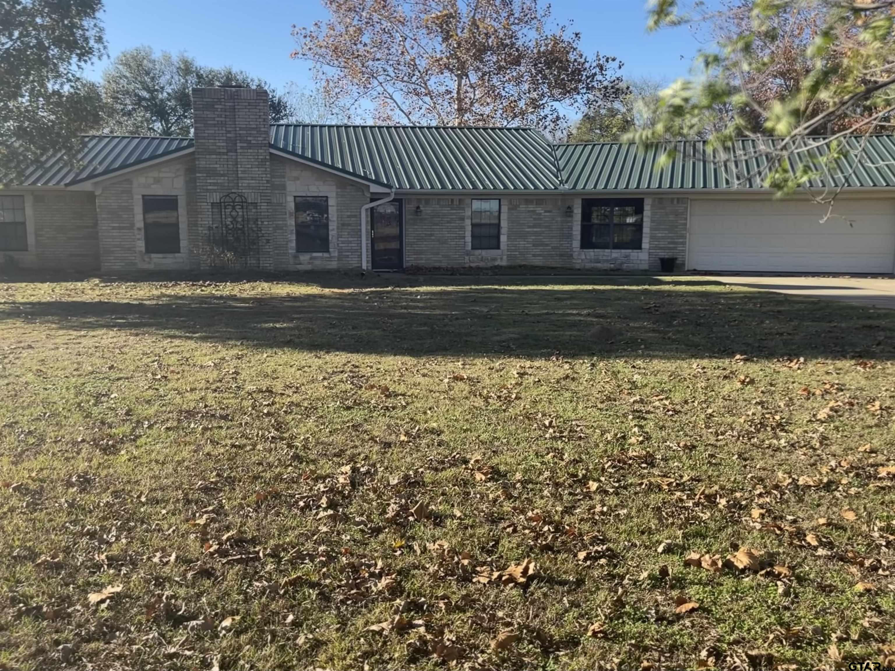 Beautiful 4 bedroom, 2 bath sitting over a little over 5 acres. All upgraded amenities - granite, wood and ceramic floors, to mention a few!! Spacious sunroom and 2 living areas. Massive covered deck all across the back for outdoor entertaining! *Shop not included* Dog friendly!