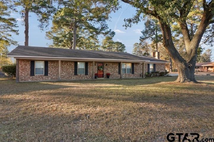 Lovely home settled on a large, almost half an acre corner lot in Gilmer, TX. With a pleasant neighborhood and beautiful trees, there is so much to love about this listing. Just off of highway 155, it has a country feel yet close to town. This home offers two comfortable living spaces, one could even be used as a formal dining space if desired. There is a cozy wood burning fireplace that's perfect for those chilly east Texas nights. You will notice this home has been updated with some great features such as new wood flooring, granite countertops, paint throughout, and walk-in showers. The roof is only five years old, HVAC system is four years old, and the water heater is about two years old. There is a built-in desk space near the utility room that would be perfect for a quiet office area. In the fully fenced, private back yard, you will find a covered patio along with a 12x16 storage shed. It is easy to see this property has been well taken care of. Don't waste any time, make an appointment for a private showing today.