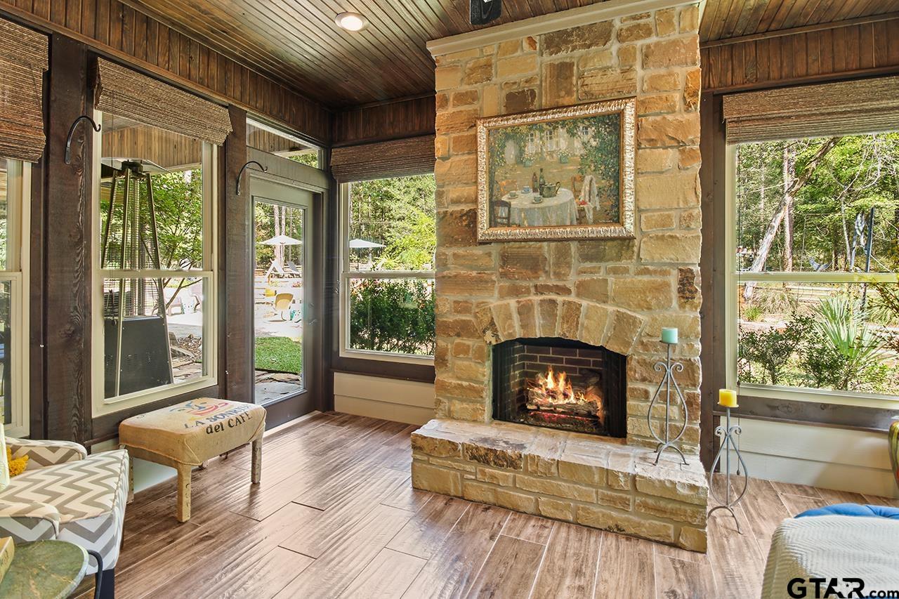 Primary Suite w/ French doors to private sunroom, fireplace and patio access.