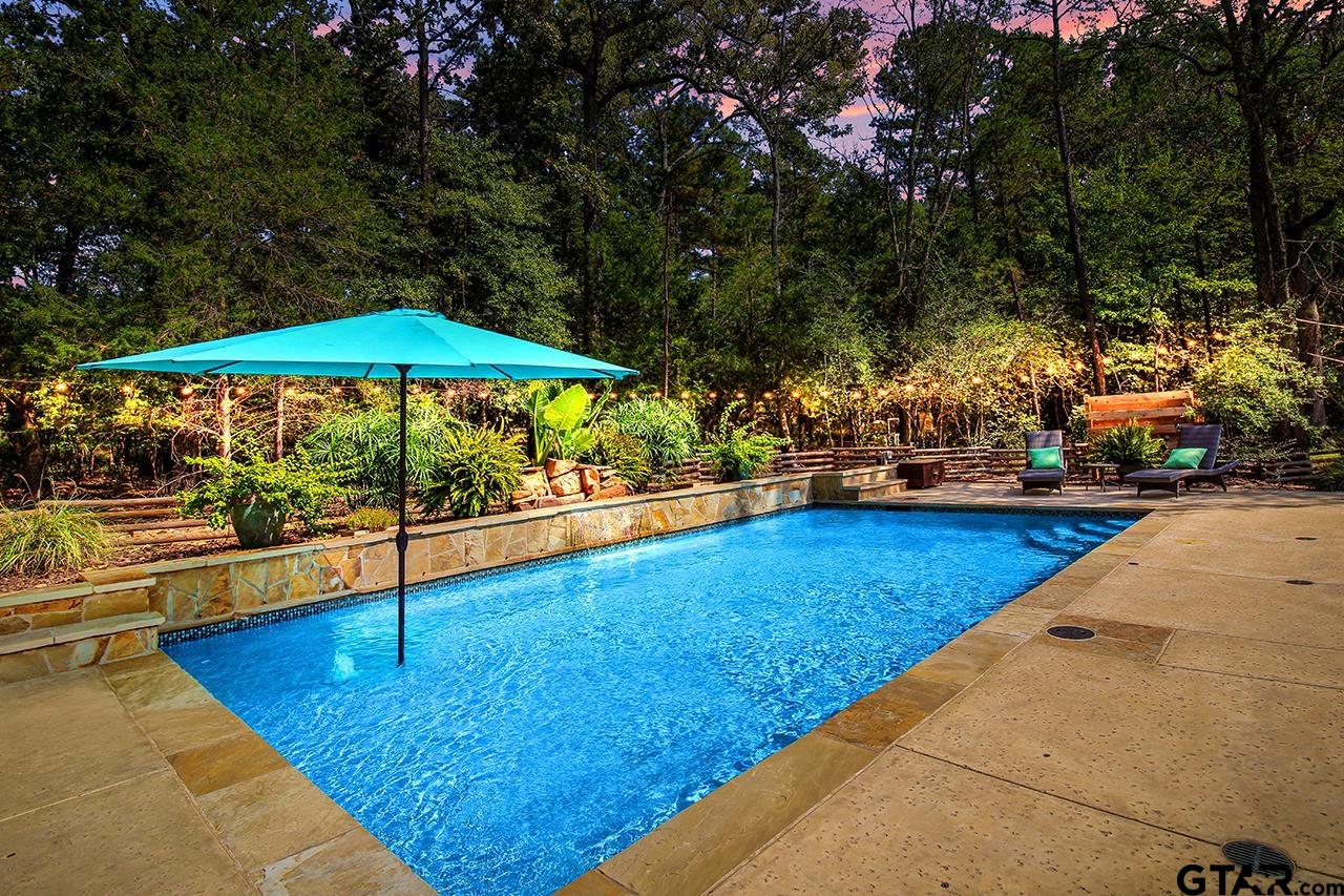 Newly built pool with a sundeck, waterfall feature, LED lights,  & poolside shower.