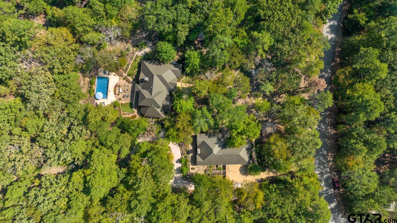 3 Acres graced with an array of tree species and colorful landscaping.