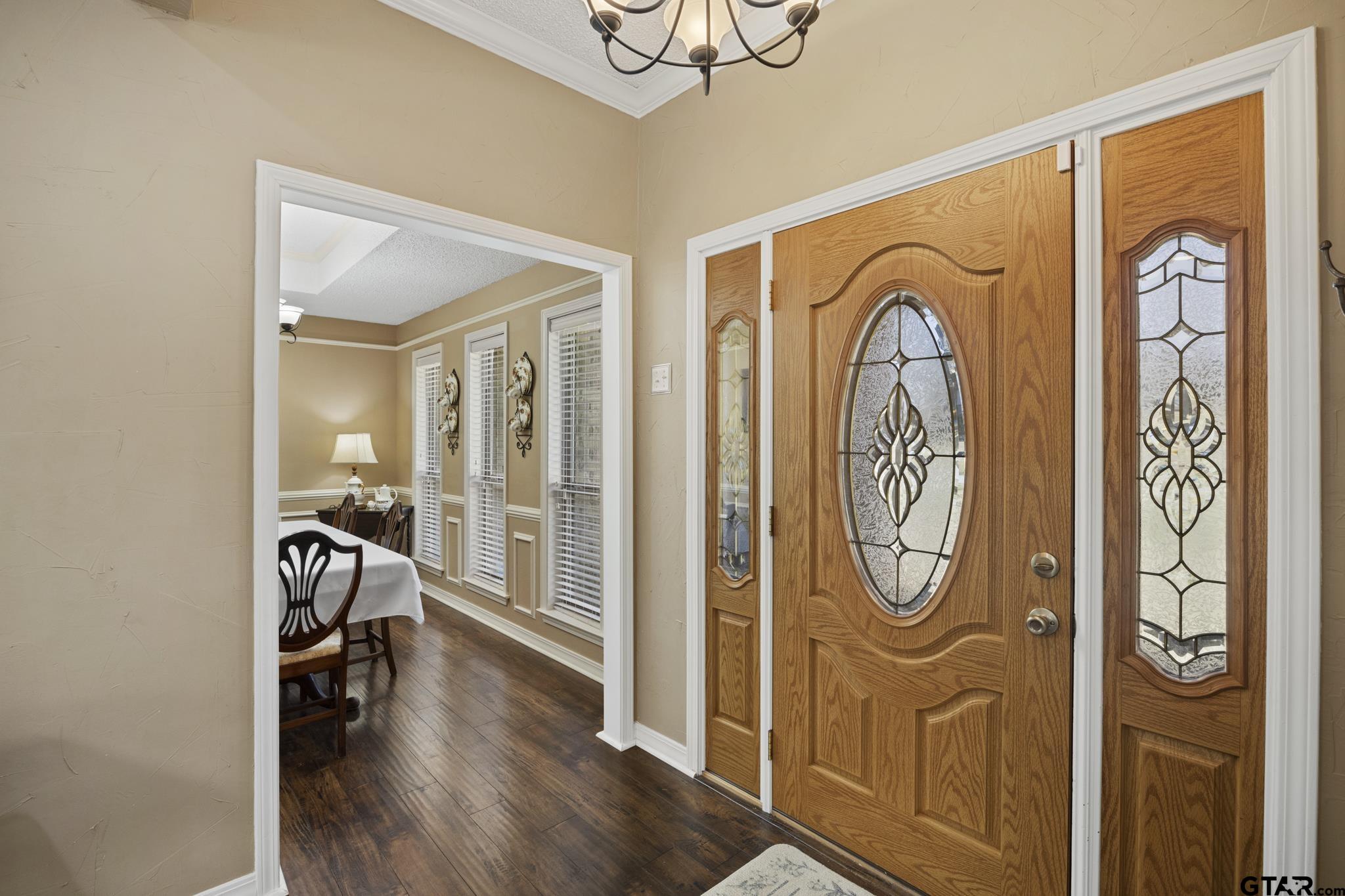 Welcoming front entry with formal dining to the right and open to main living space.