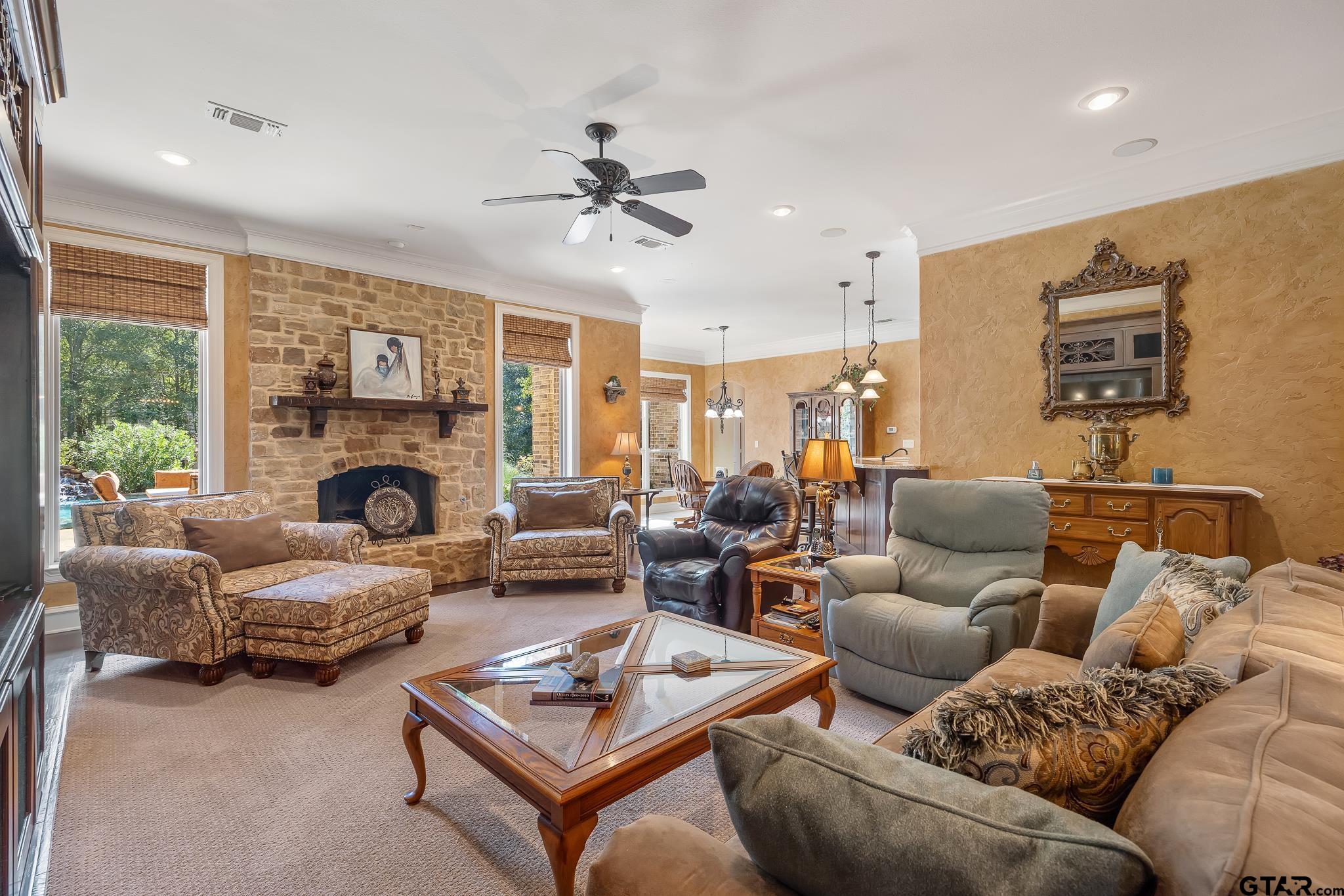 Open to kitchen & dining, this spacious living room is set up for entertaining guests and family.